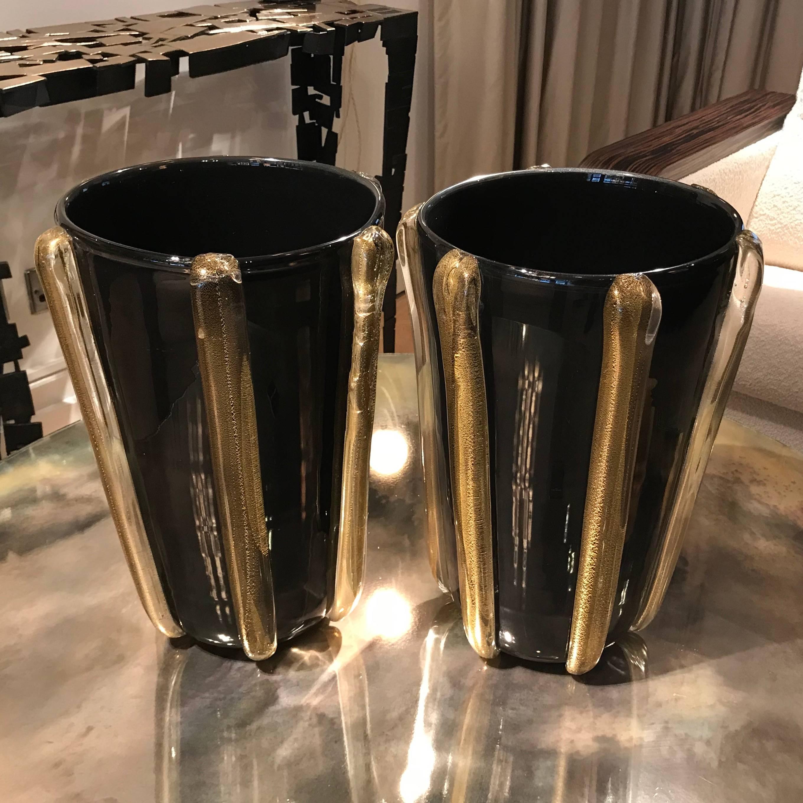 A pair of signed Contantini Murano vases made from black glass and clear glass strips embedded with gold leaf. 

Signature on the bottom of each vase.