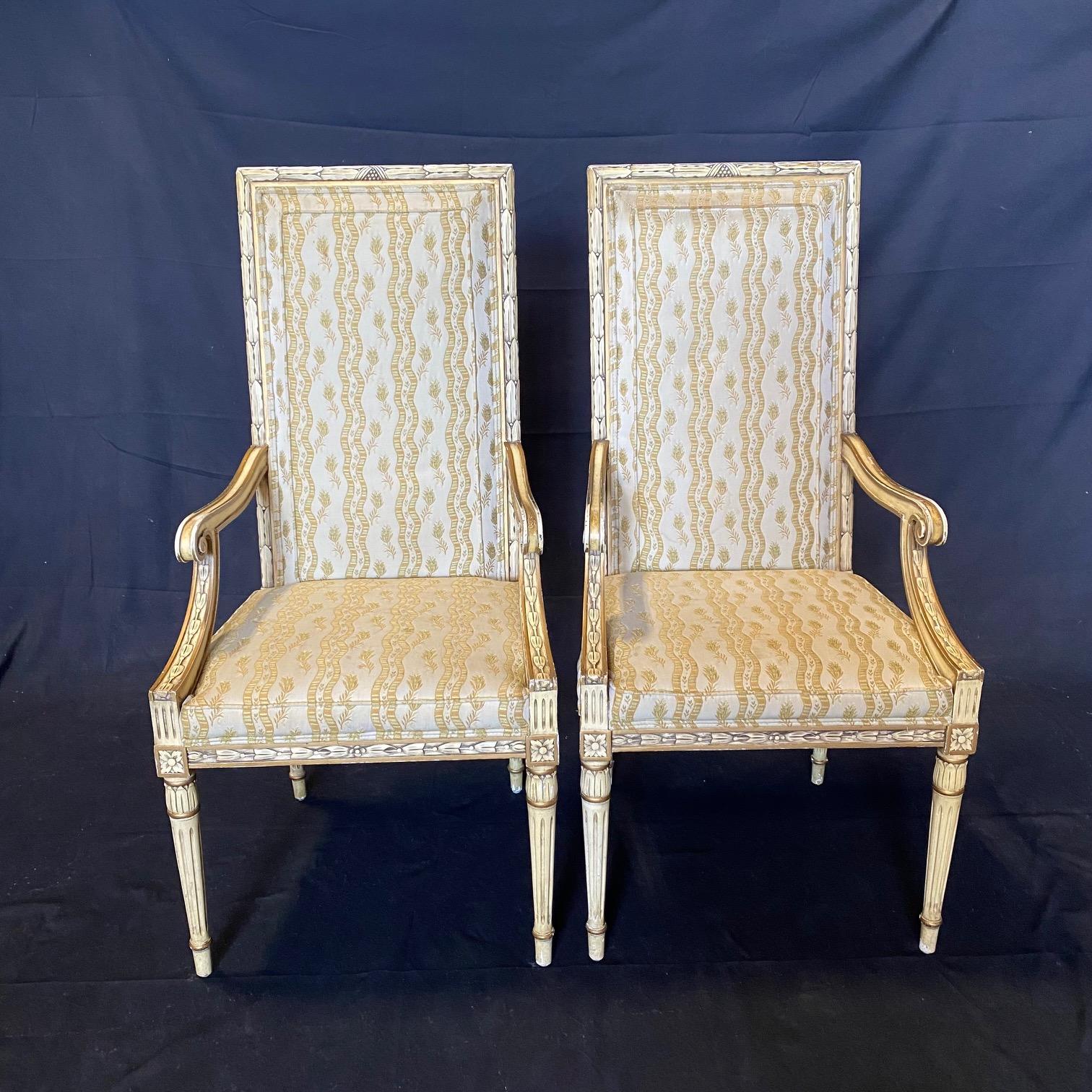 Two classic vintage Karges French Empire neoclassical dining chairs, arm chairs or accent chairs. These luxurious chairs are painted white with gold carved accents, scrolled arms, saber legs and original super luxe upholstery. seat height 18.5 arm