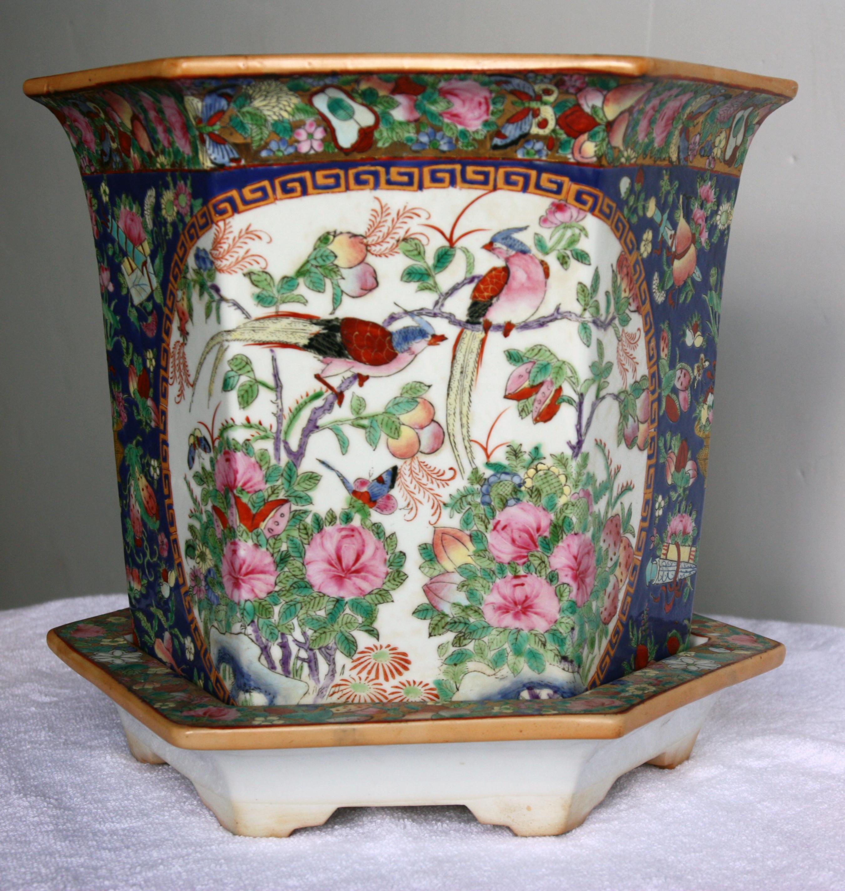 Pair of different sized, beautifully hand-painted jardinières with plates. Signature stamp on the bottom.  One large and one small. They both depict a garden scene with birds. 


Dimensions of smaller jardinière:
Diameter 6.5