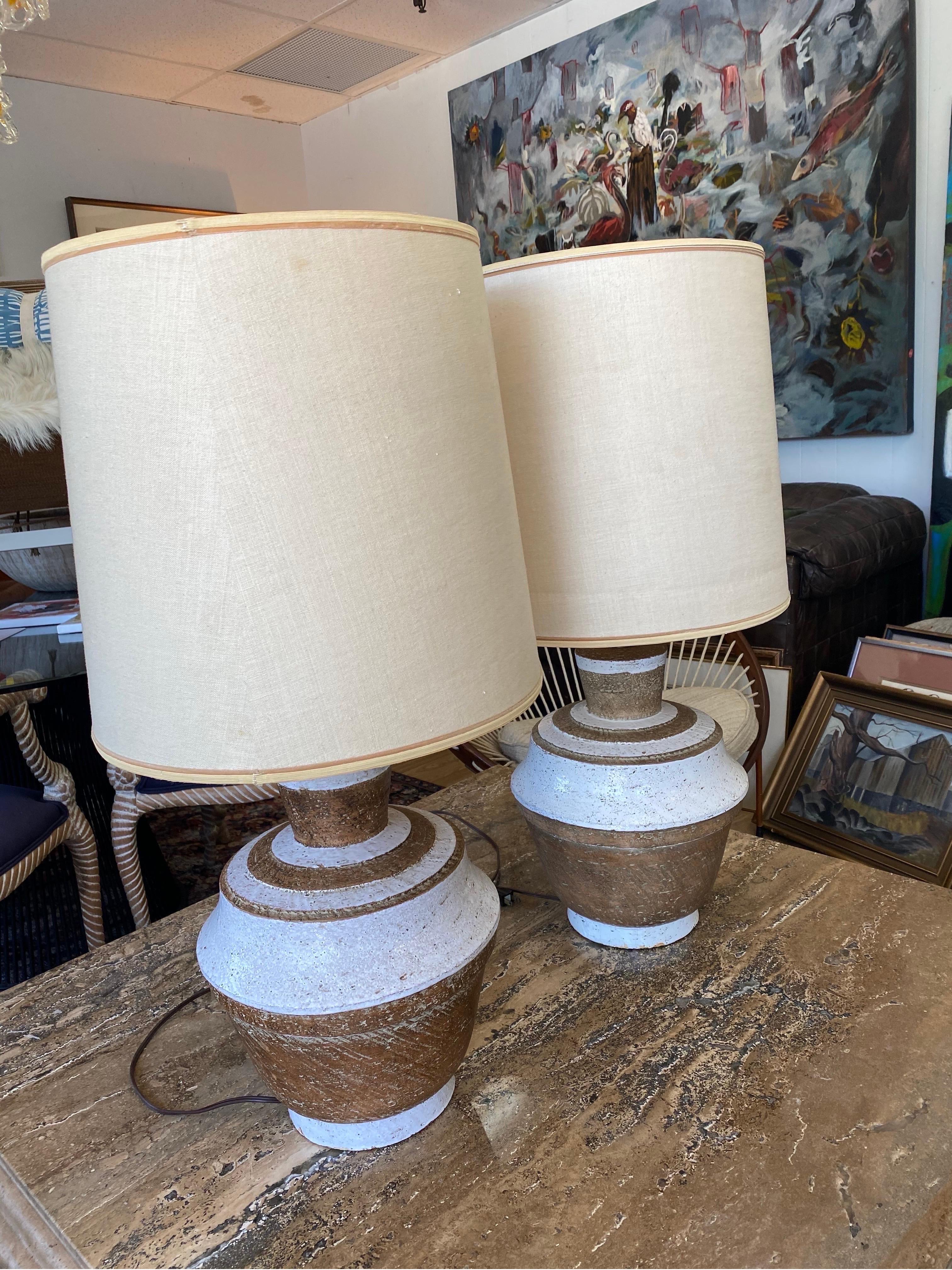 Beautiful pair of ceramic Italian table lamps by Urbano Zaccagnini for Raymor, Italy, circa 1950s. Lamps are signed and feature white glazed lines over terracotta. Diffusers are attached and shades can be included but did not come with lamps. Normal