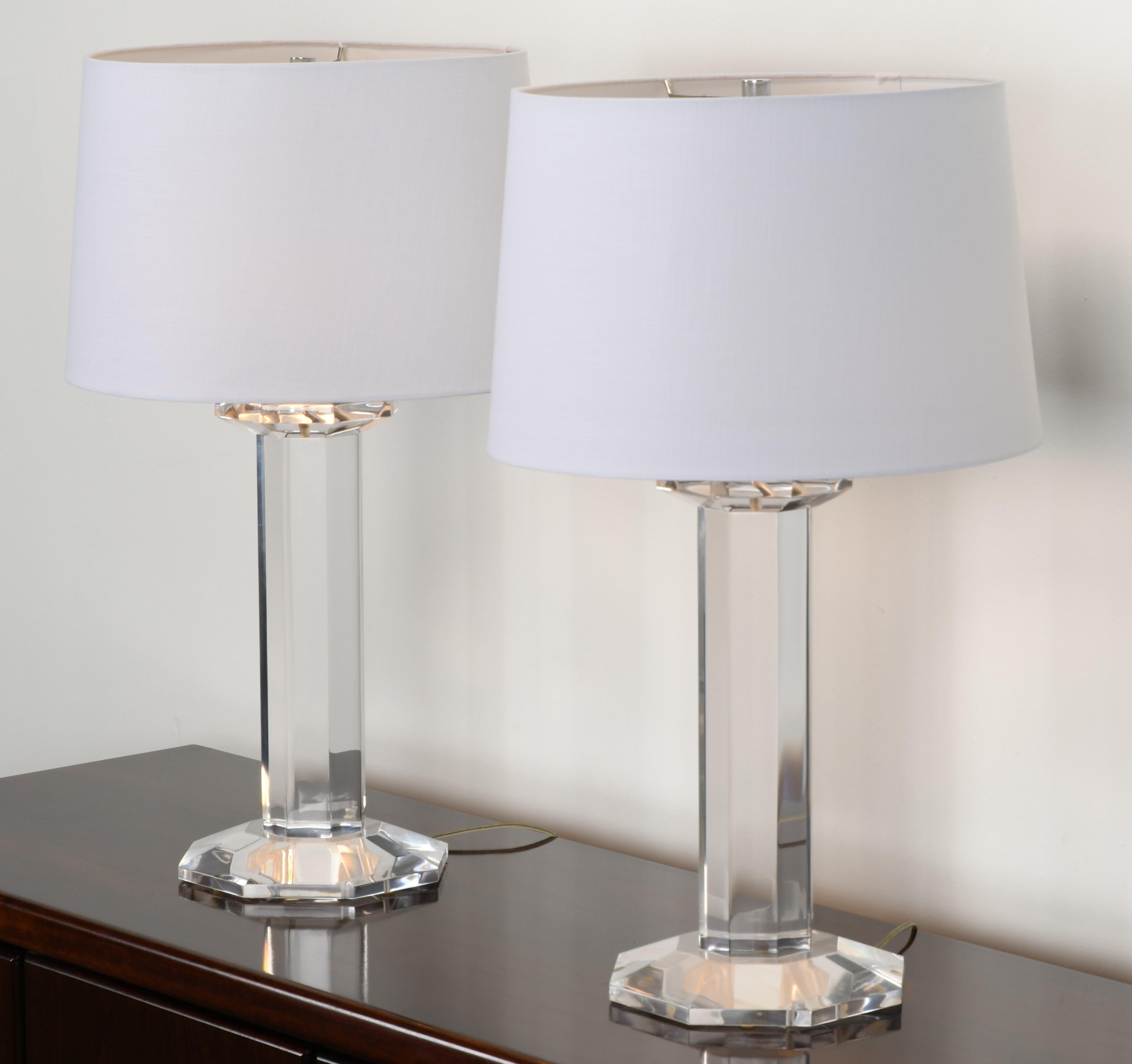 A pair of large column table lamps made of solid Lucite by Karl Springer, American, 1980s. Signed on top of the column, as shown in images. Very good condition. Shades not included. 

Dimensions: 28.5
