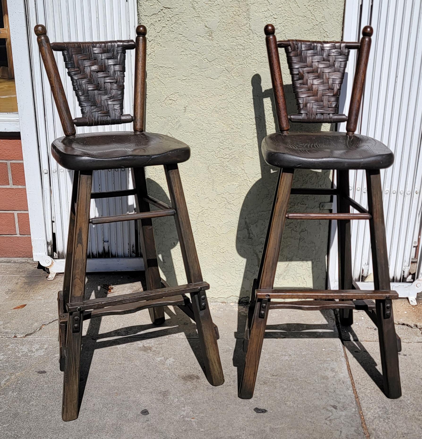 Pair of 1940's signed old hickory bar stools. These stools are rare and hard to find.

Measures: 42 High
14.4 Seat Width
15 Dept
30 Seat Height.