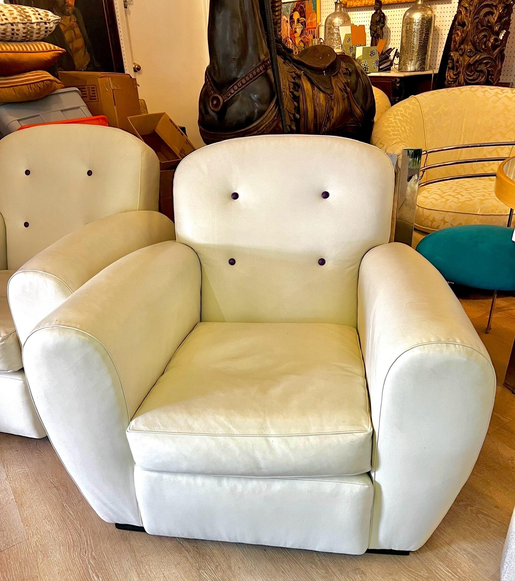Rare, vintage signed Ralph Lauren blue label leather club chairs.  Done in an off white leather with subtle purple leather button.  Art Deco vibes throughout and one of the most comfortable chairs we have ever sat in - and we've been in business