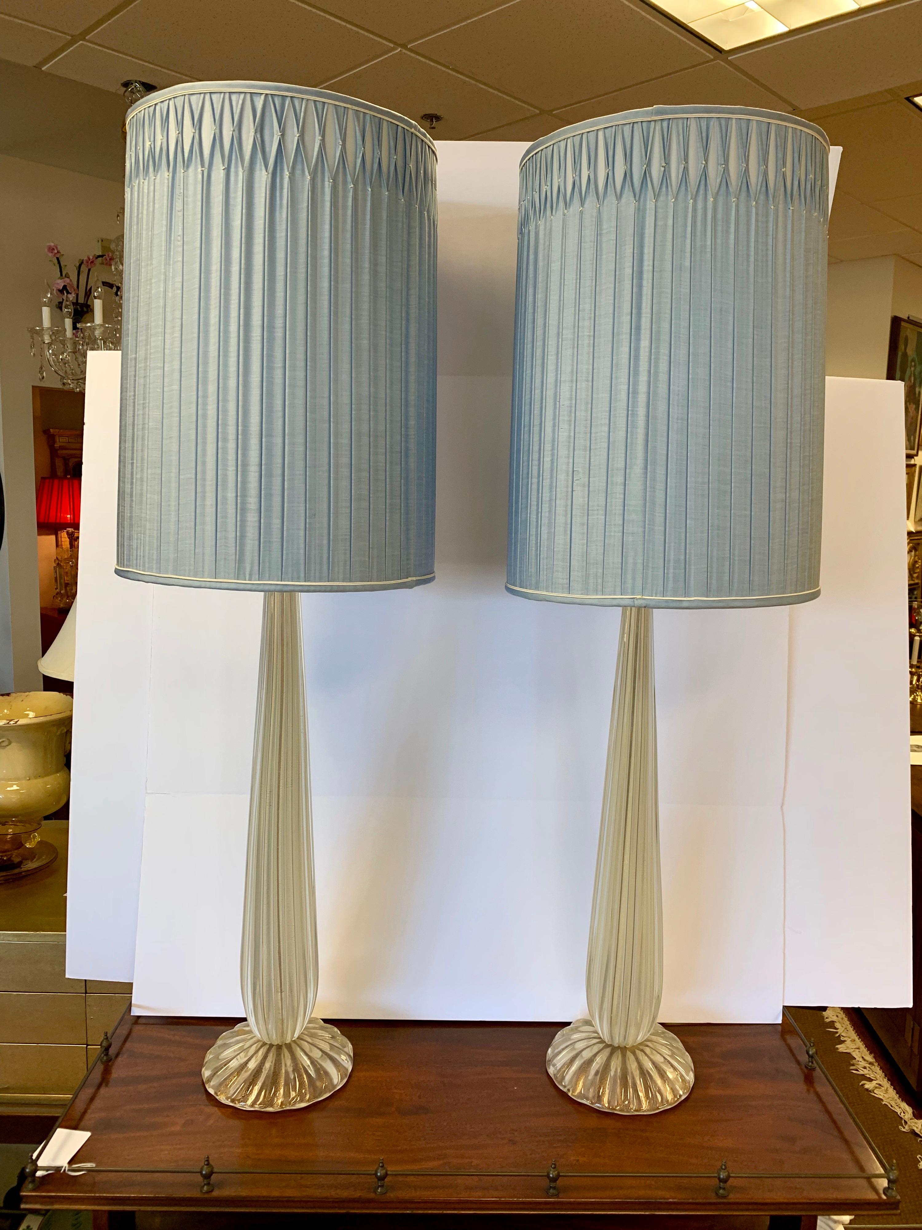 Stunning, very tall pair of signed Salviati Murano glass table lamps. Wired for USA and in working order.
Made of all Murano glass with gold specs. So sought after in this rare, tall size with original sky blue pleated shades which look like