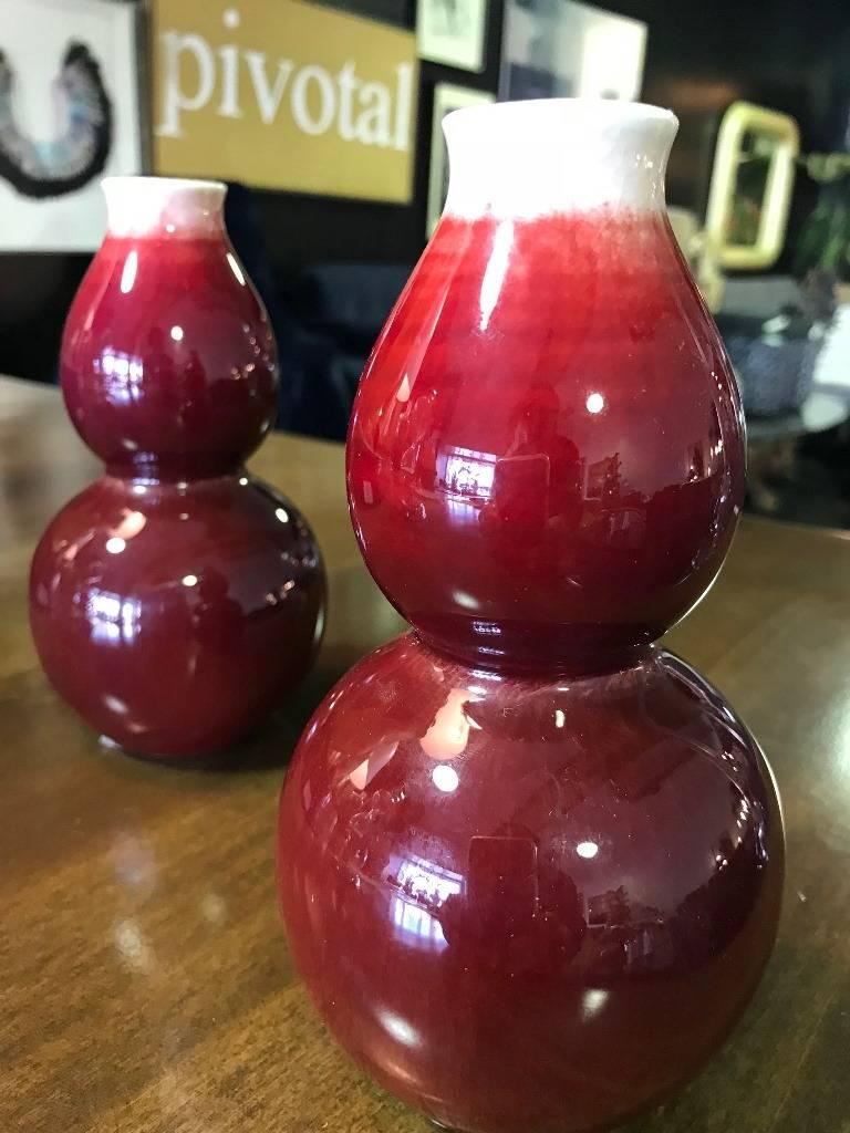 Pair of exquisite Chinese oxblood double gourd vases. Rather stunning and very distinctive deep red color or glaze. Both vases are signed or stamped on the bottom. Quite eye-catching works. 

Dimensions: 6 3/4 