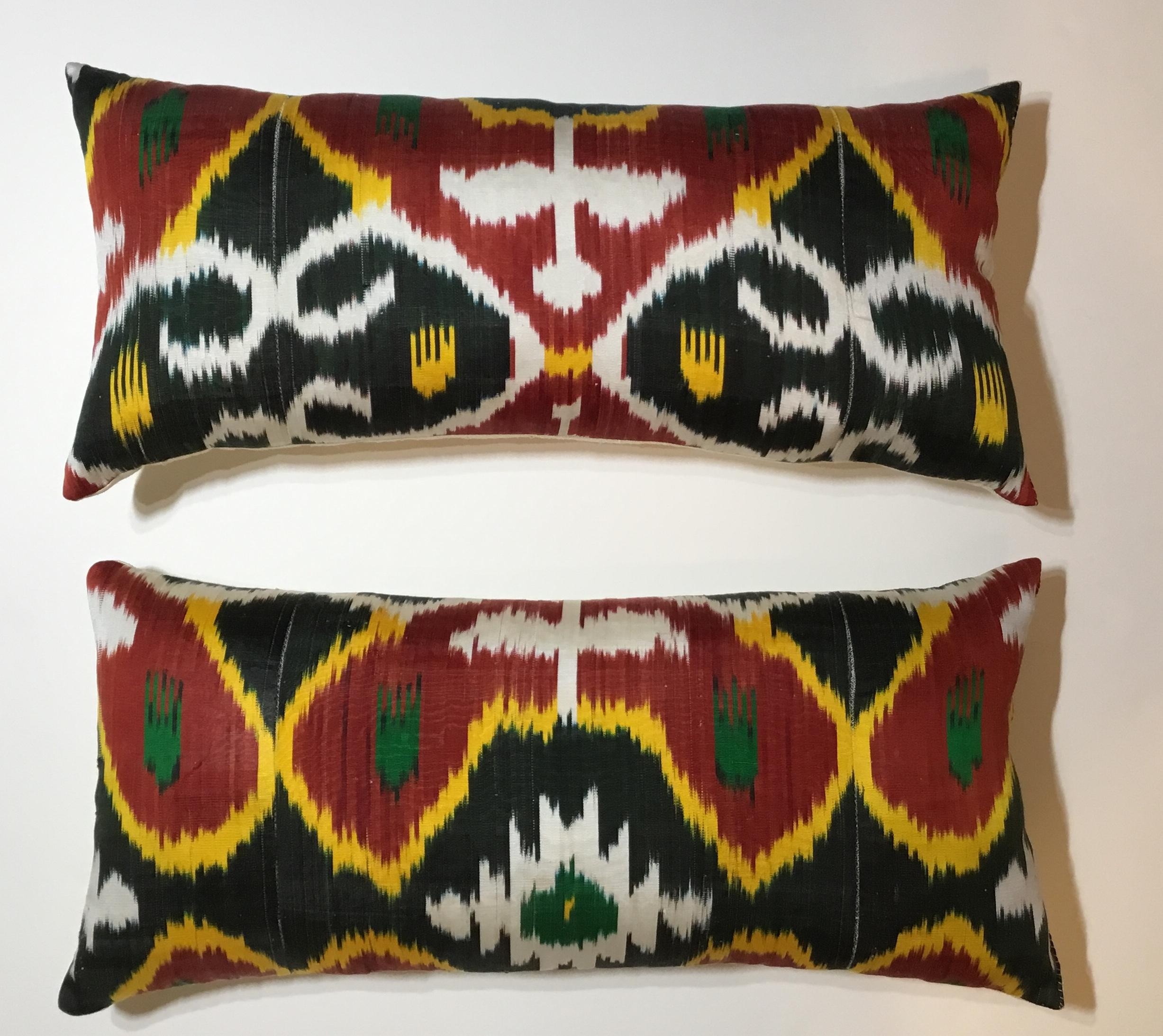 Beautiful pair of pillows made of silk Ikat textile vibrant colors of red-salmon, black white and yellow-muster, Frash new insert ,and fine silk backing .