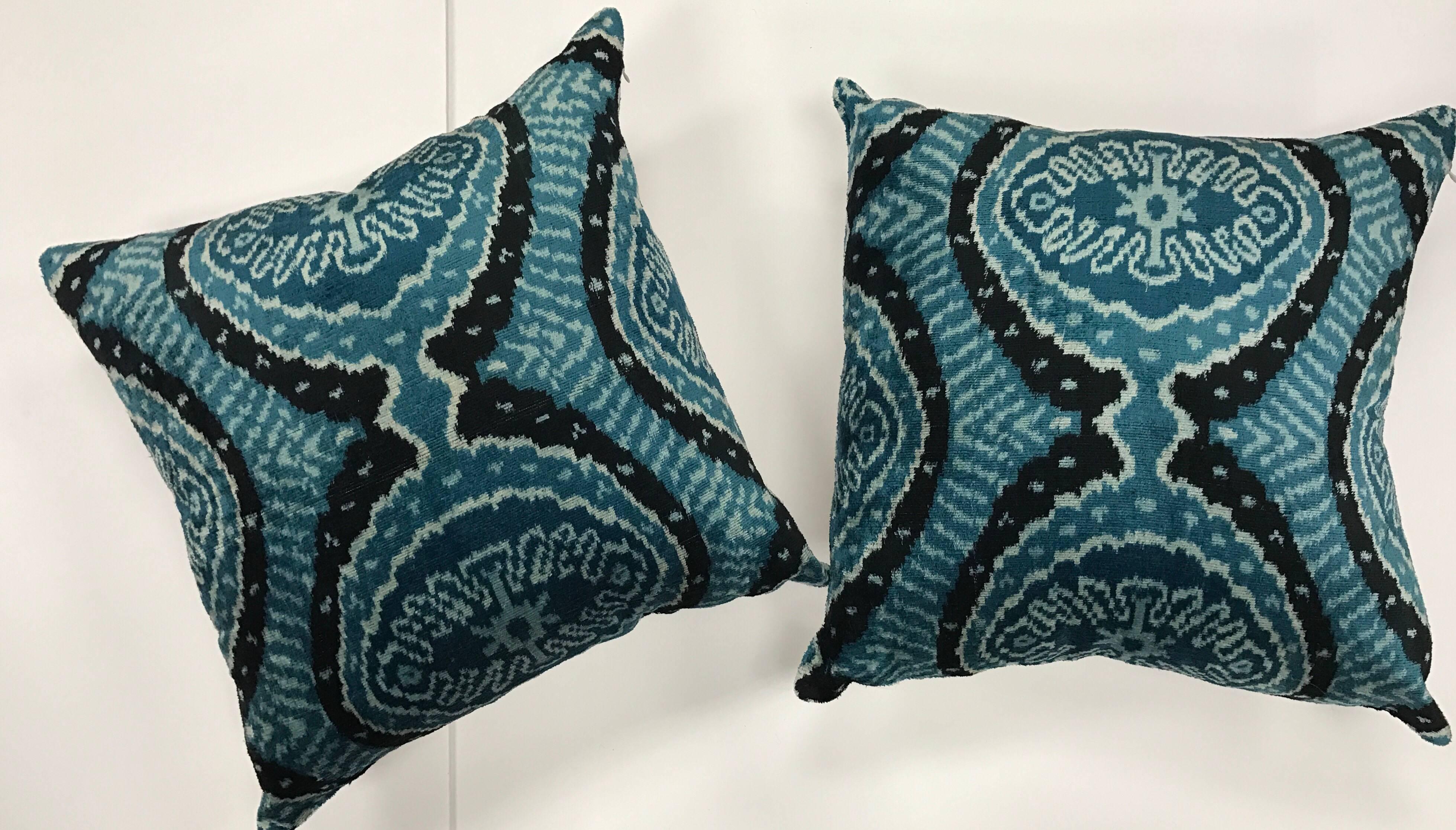 With their brilliant colors and bold design, Ikats are some of the most distinct and sought after fabrics produced in the world. This pair of handmade silk Ikat pillows are down filled and both tied and dyed by hand. This makes each Ikat design one