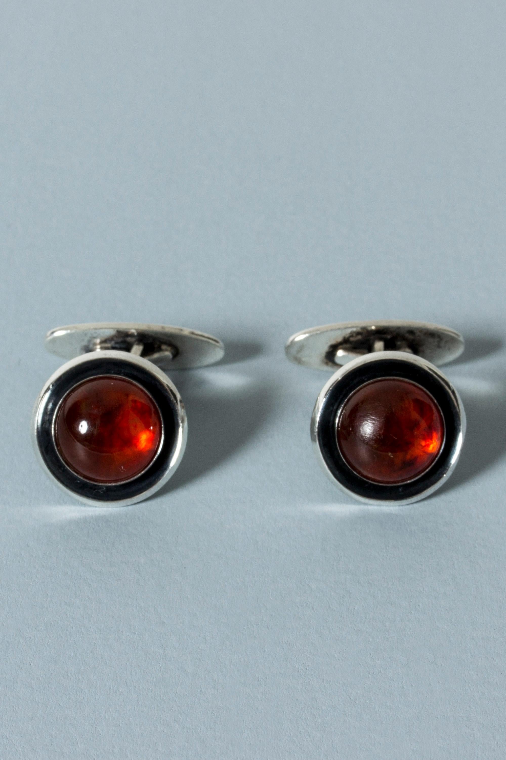 Pair of silver and amber cufflinks from Niels Erik From, in a lovely round form. Blackened backdrop to the glowing stones.