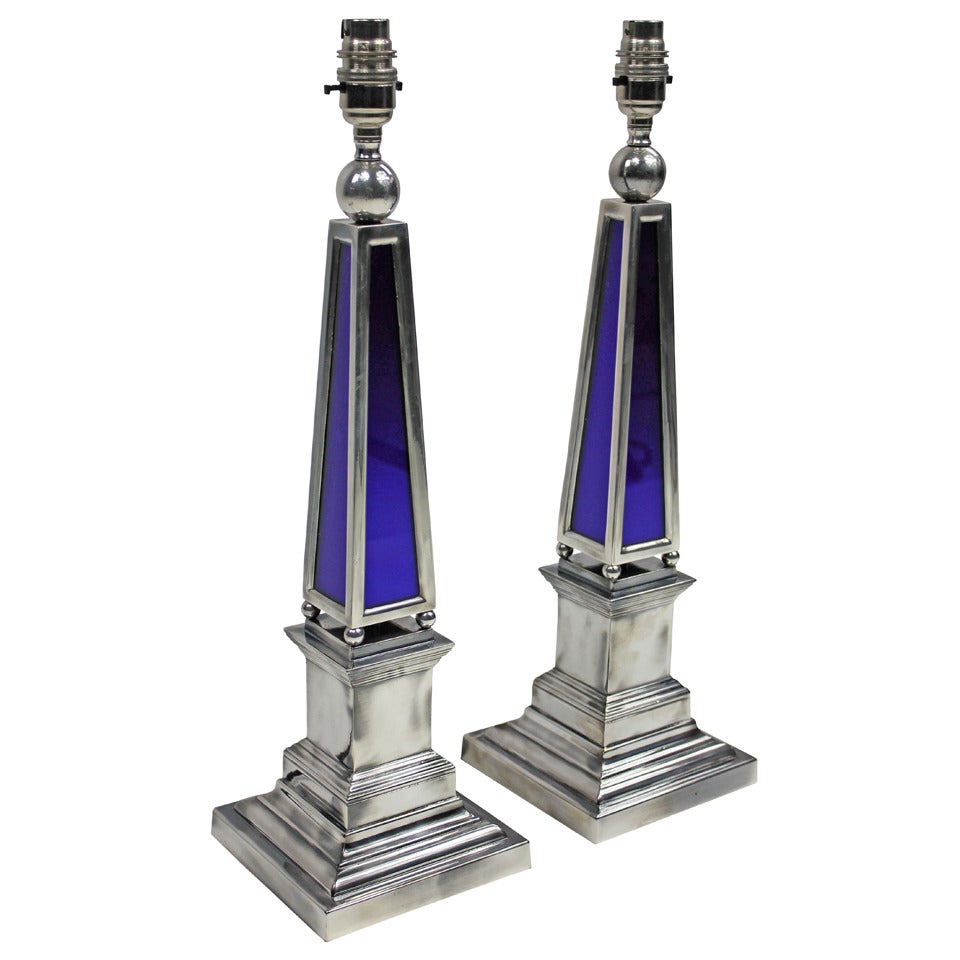 A pair of English silver plated obelisk lamps with blue glass panels.

These lamps are made to order for Ebury Trading.

These items are subjected to VAT.