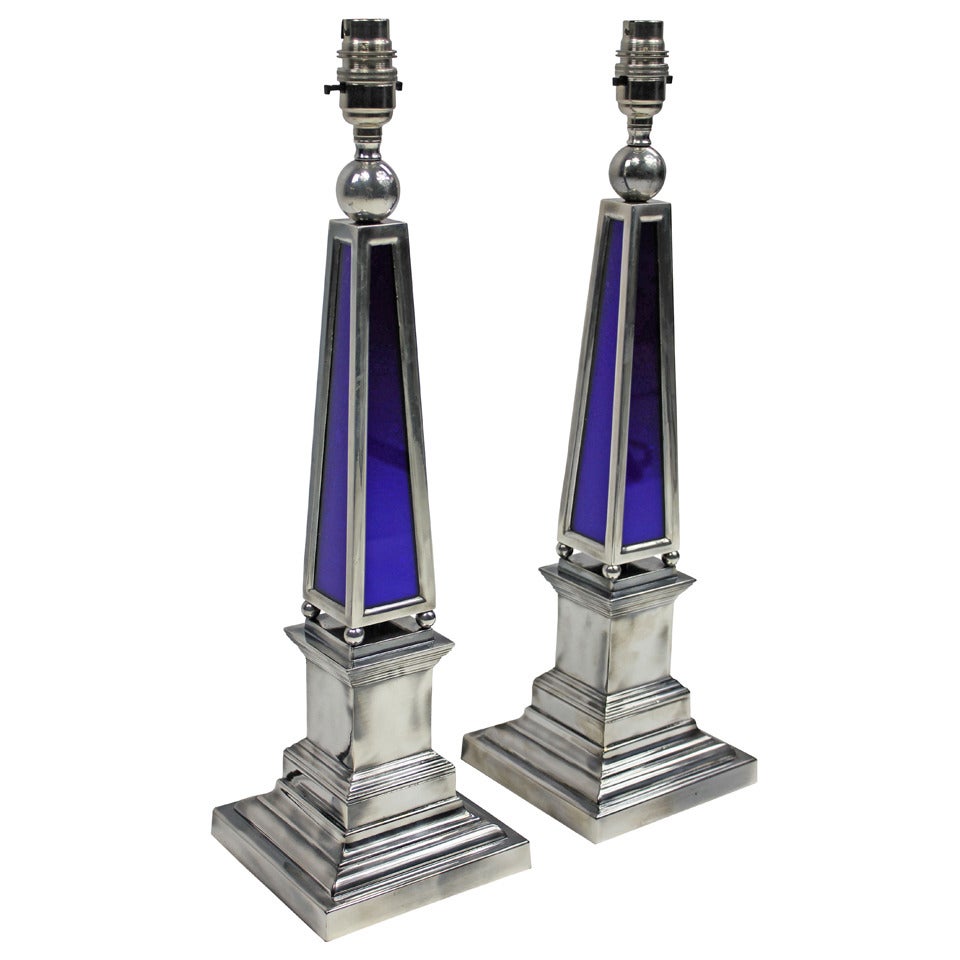 A pair of English silver plated obelisk lamps with blue glass panels.

These lamps are made to order for Ebury trading.

These items are subjected to VAT.