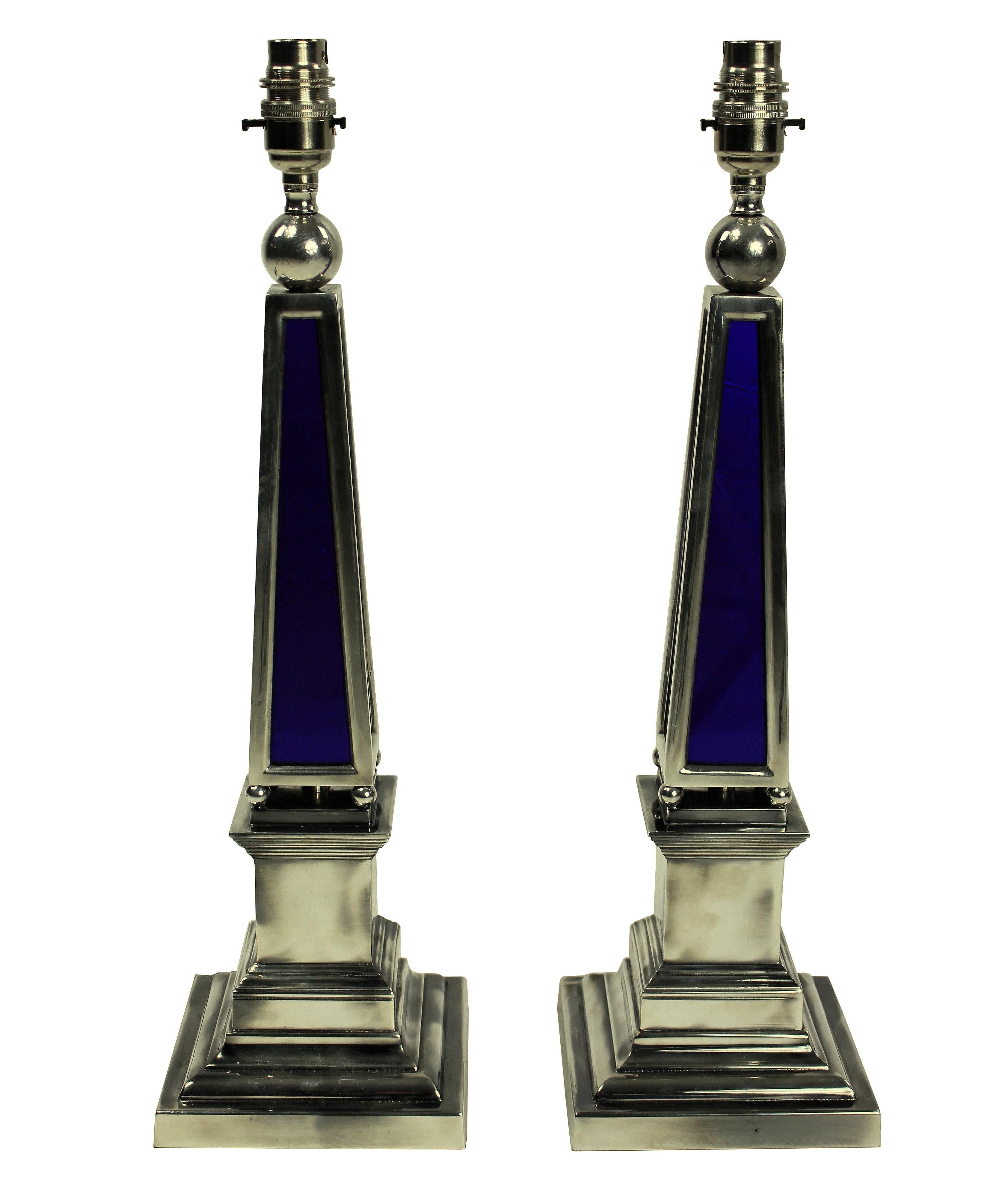 A pair of English silver plated obelisk lamps with blue glass panels.

These lamps are made to order for Ebury trading.

These items are subjected to VAT.