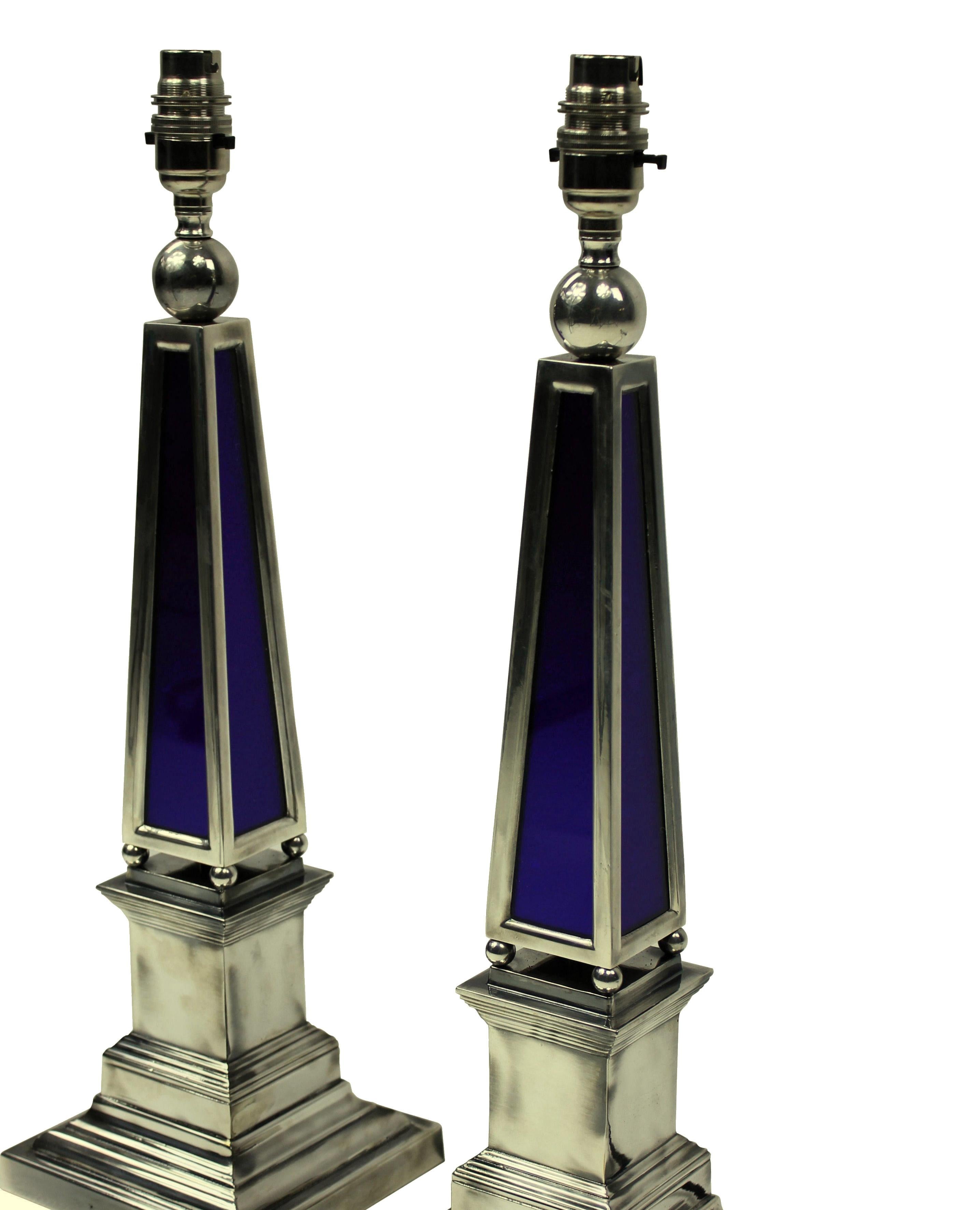 A pair of English silver plated obelisk lamps with blue glass panels.

These lamps are made to order for Ebury trading.

These items are subjected to VAT.