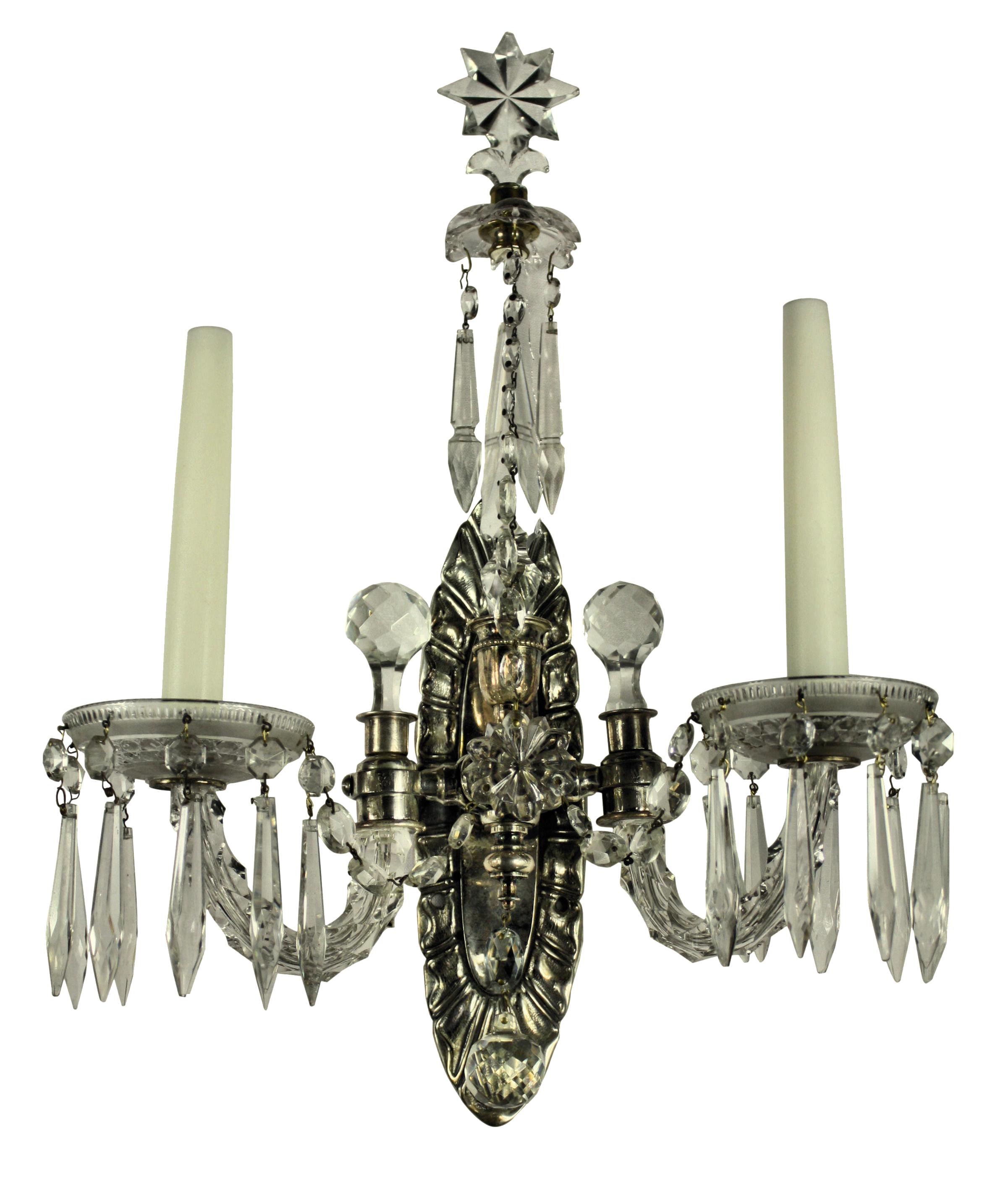 A pair of English, twin branch wall lights of in silver and cut glass, with spires terminating in stars with swags and pendants.