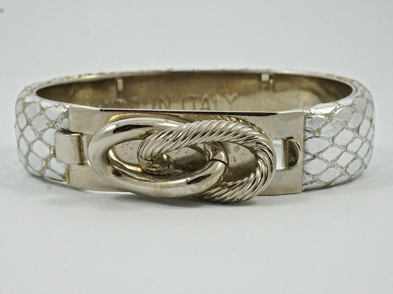 Wonderful leather lizard design bangle bracelets with decorative clasps, made in Italy. There is a silver leather bangle with silver tone metal, and a grey iridescent bangle with gold tone metal.  They both measure approximately inside diameter