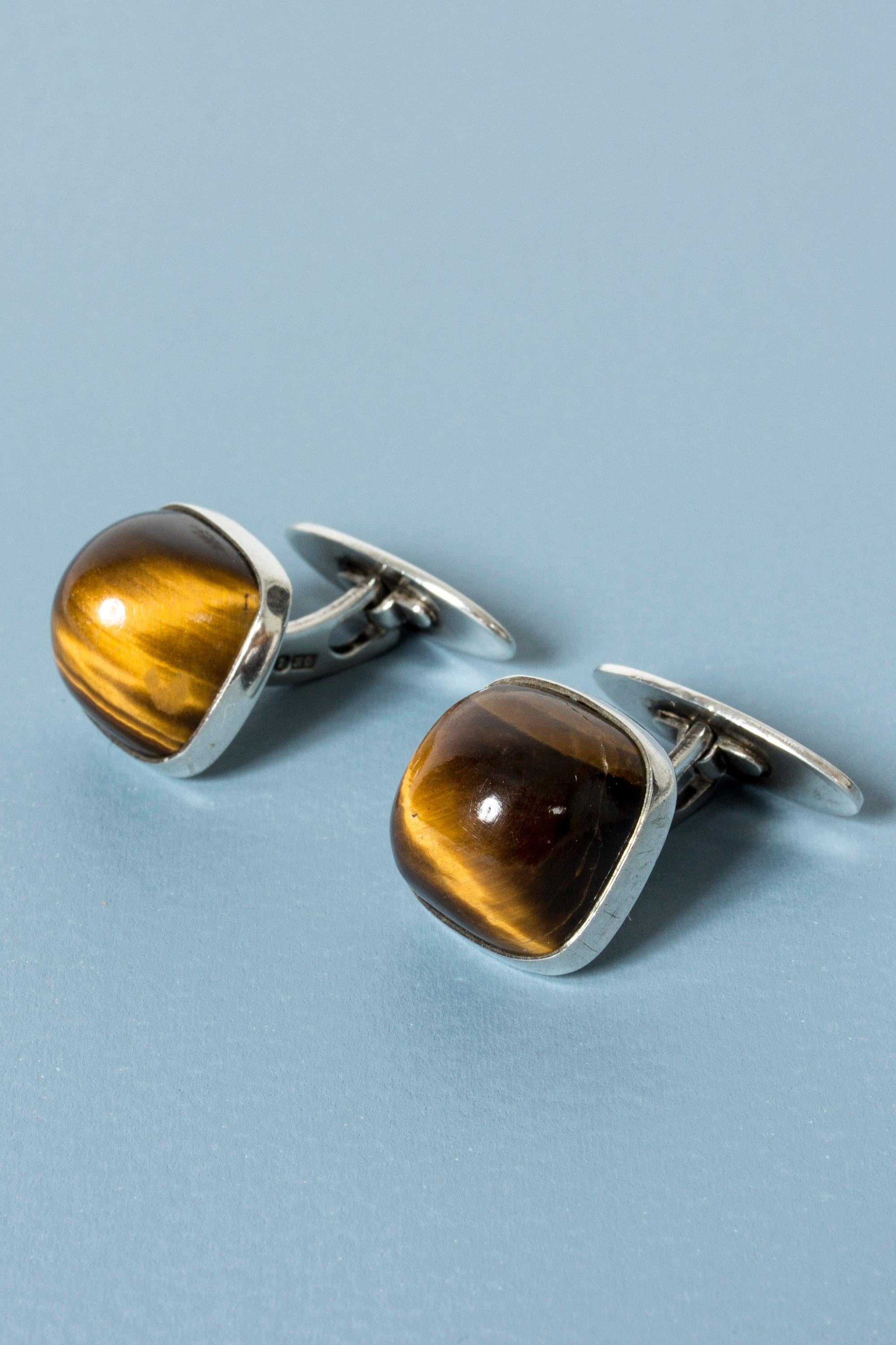 Pair of cool silver and tigereye cufflinks from Kaplans, with large, rounded, protruding stones. Warm, toffee colored stones.