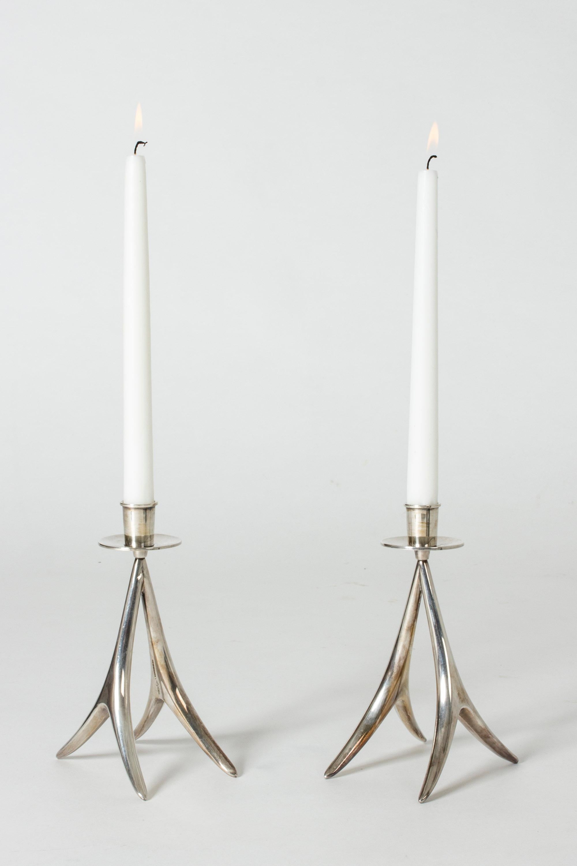 Pair of graceful silver candlesticks by Anna Greta Eker for Kultateollisuus Ky. Nice combination of modernism and organic influences.