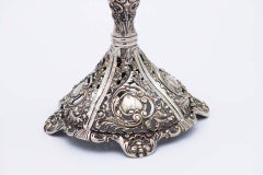 Pair of silver candlesticks with embossed stems and sconces