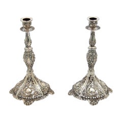 Pair of silver candlesticks with embossed stems and sconces