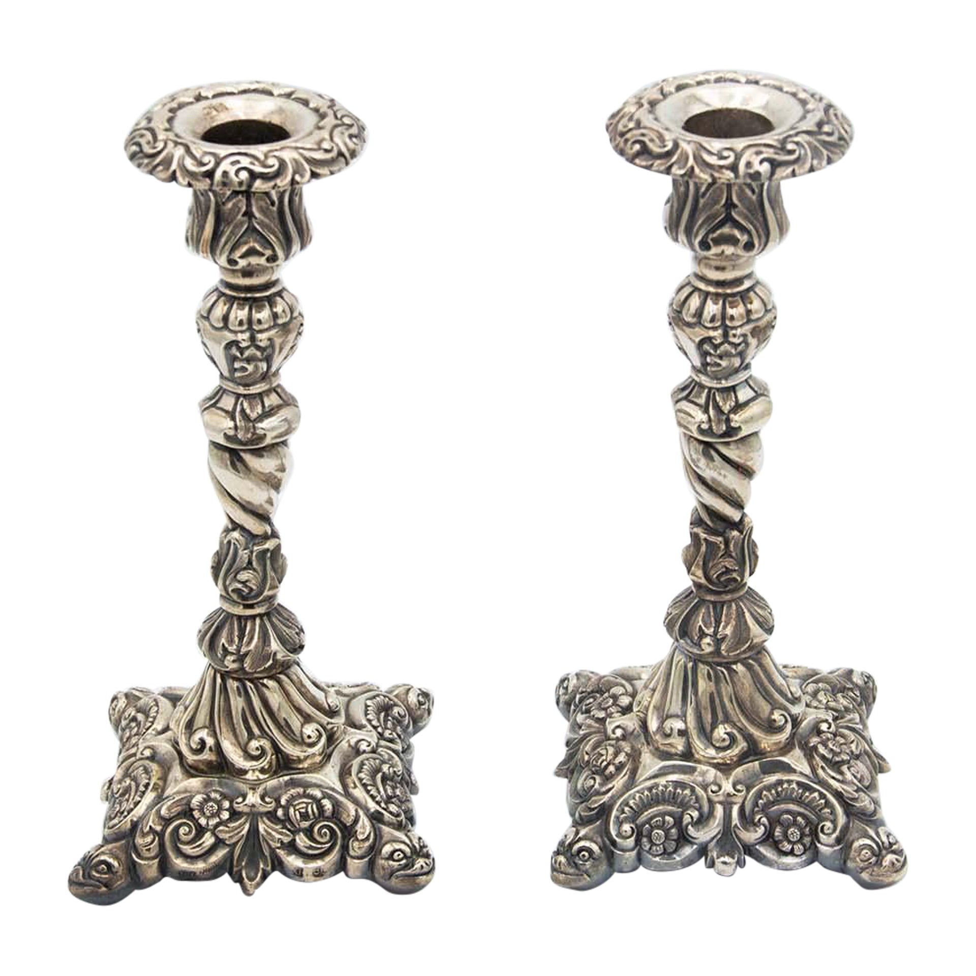 Pair of silver candlesticks with high reliefs