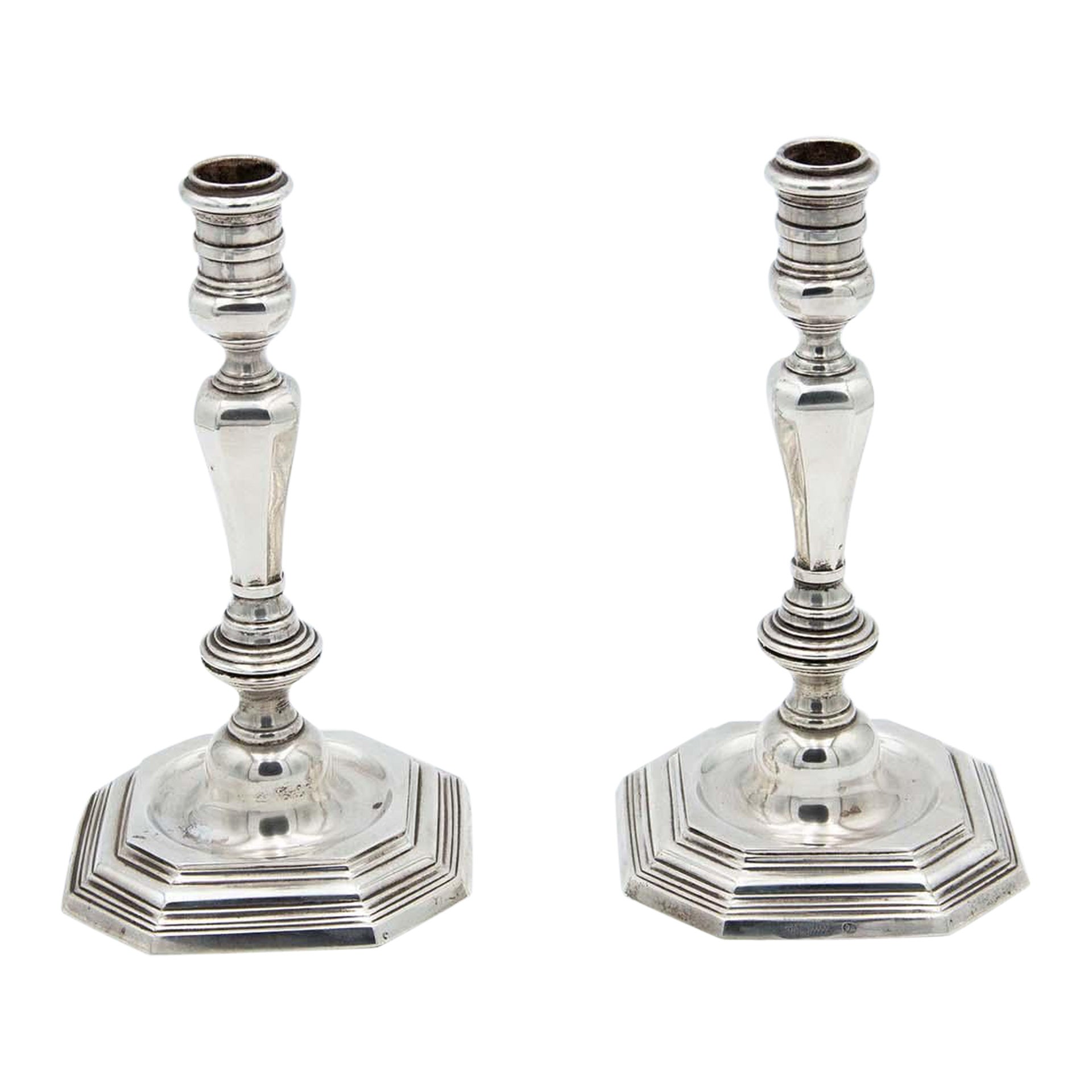 Pair of silver candlesticks with octagonal bases in relief