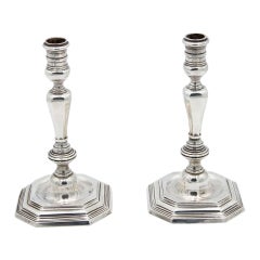 Pair of silver candlesticks with octagonal bases in relief