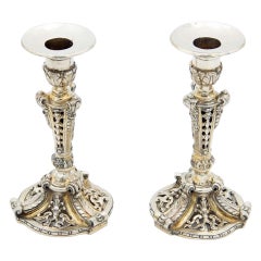 Pair of silver candlesticks with openwork cutouts