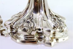 Pair of silver candlesticks with palm and acanthus stems on cutout bases