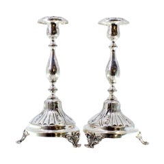 Pair of silver candlesticks with turned engraved shafts on three-foot bases