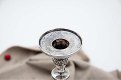 Pair of silver candlesticks with turned stems, floral reliefs, square bases