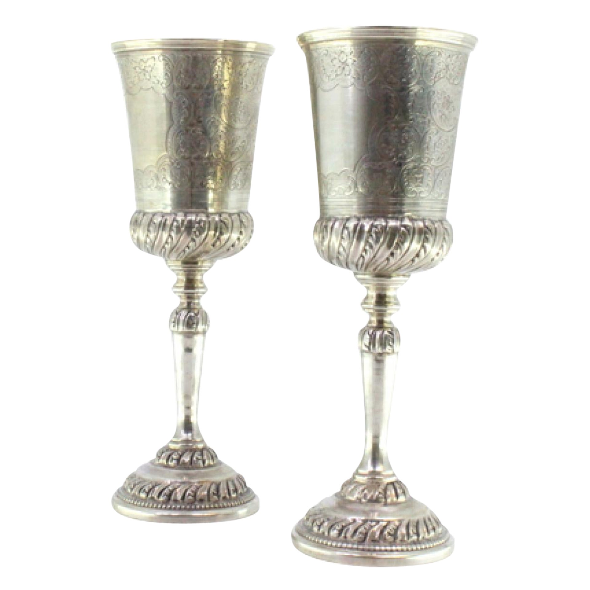 Pair of silver chalices with engravings and relief friezes on the circular bases