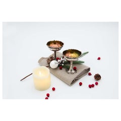 Pair of silver champagne glasses with raised rims and bases and gold interior