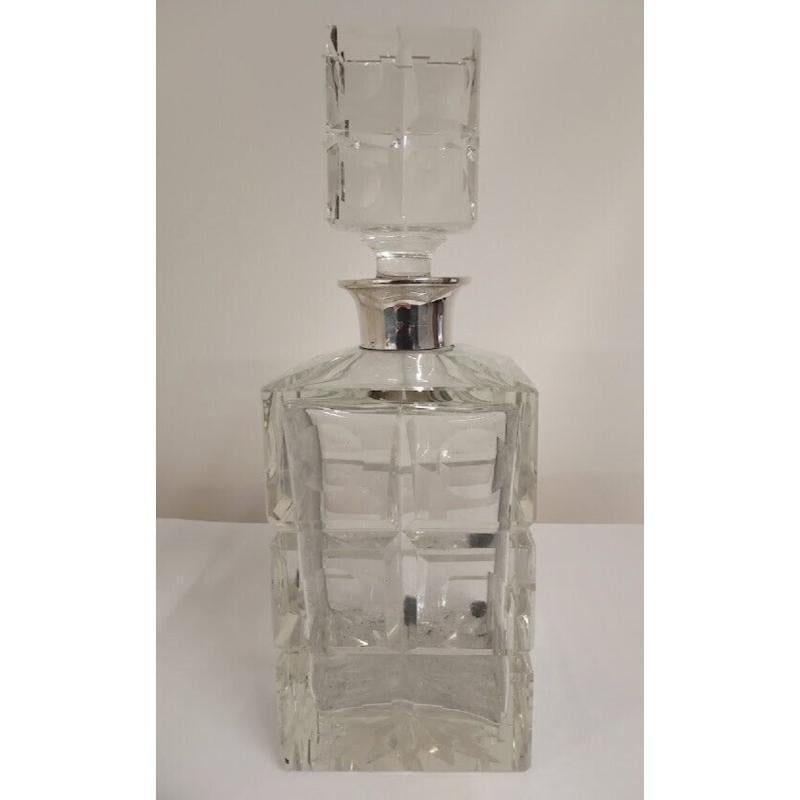 This beautiful pair of heavy whiskey decanters are decorated with stylish modern circles. They have sterling silver collars and are in excellent condition. Hallmarked: Made by Garrard & Co Ltd in Regent Street London in 1964.

Additional