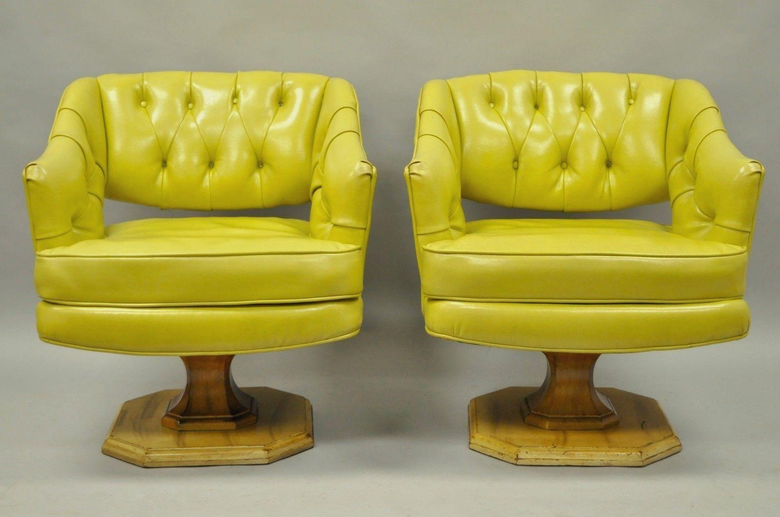 Great pair of vintage Mid-Century Modern greenish yellow tufted vinyl swivel club lounge by Silver-Craft Furniture Co. Item features solid wood frames, swivel pedestal bases, vinyl upholstery, button tufted backs, quality American craftsmanship,