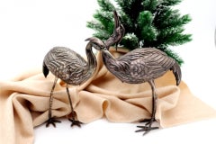 Pair of silver cranes with profusely embossed applications