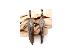 Pair of silver cranes with profusely embossed applications