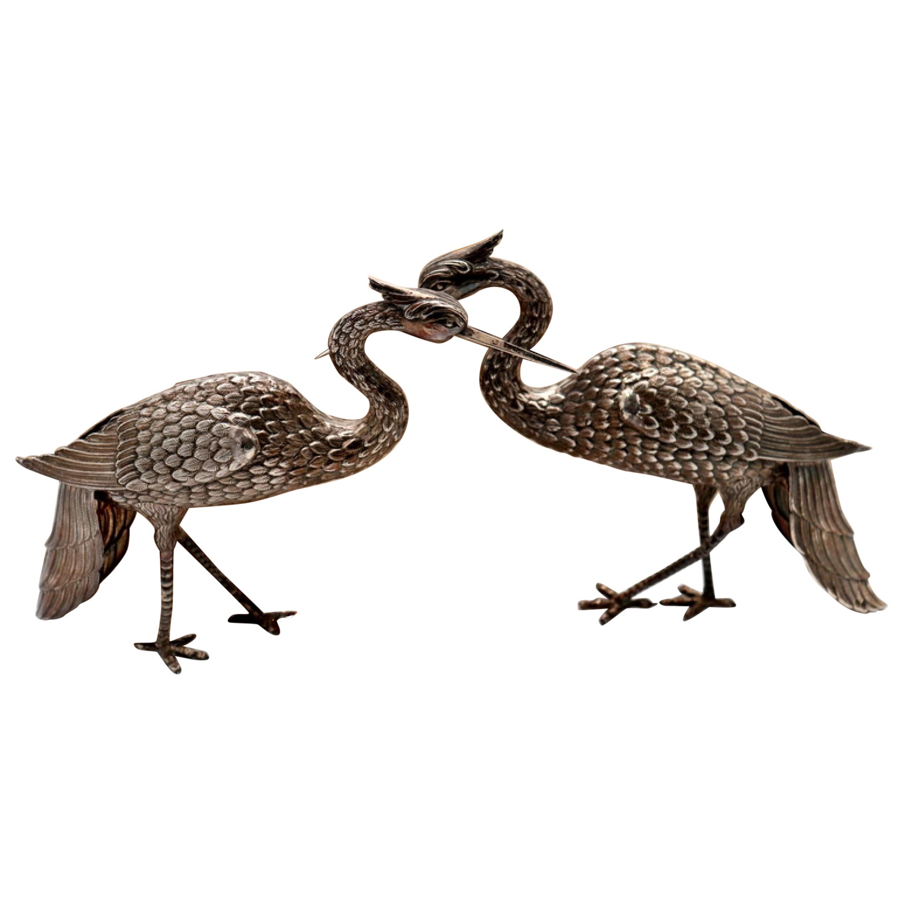 Pair of silver cranes with profusely embossed applications en venta