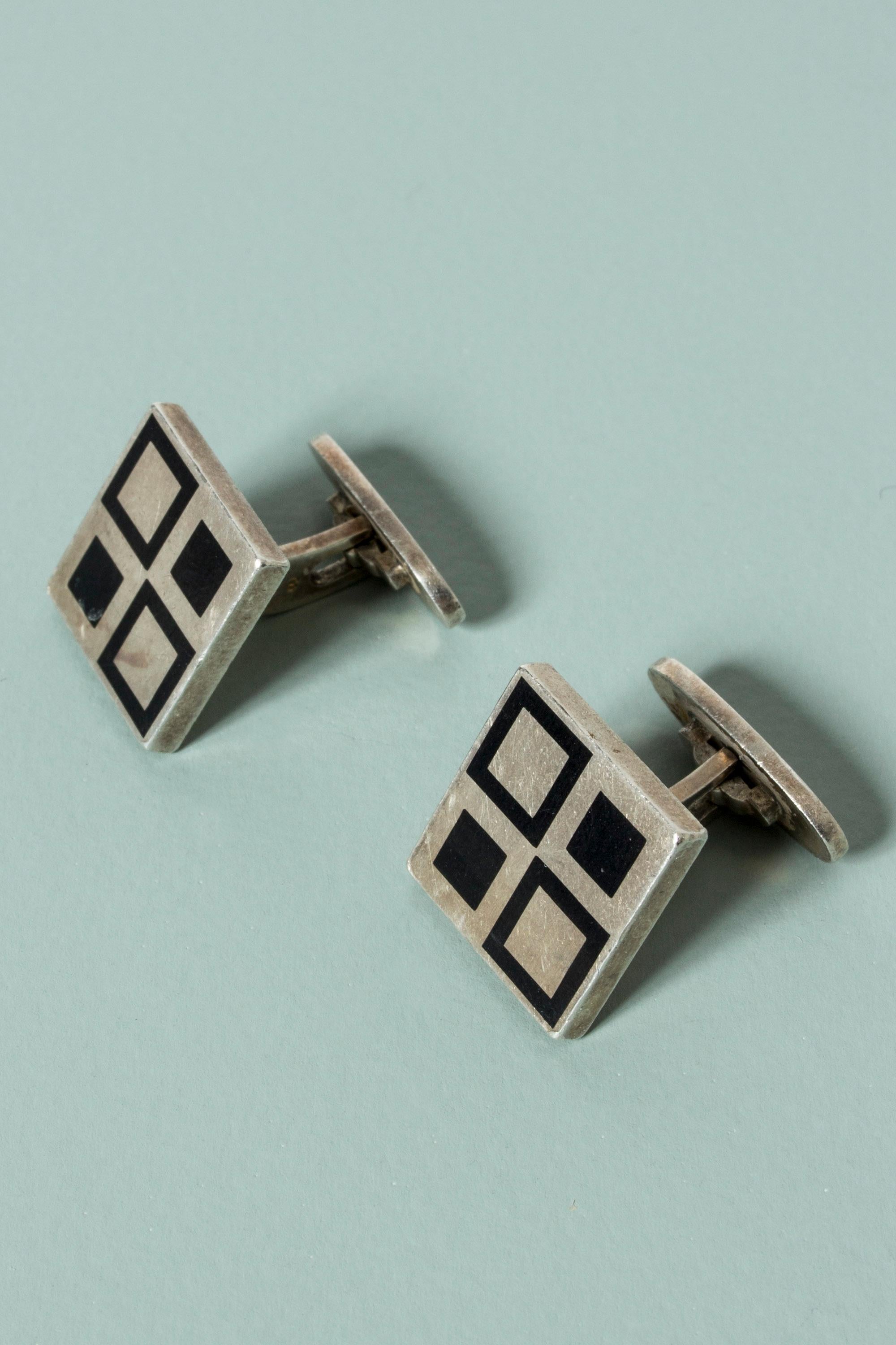 Pair of cool silver cufflinks by Magnus Steffensen with a graphic pattern in black enamel. Crisp and playful design that stands out.