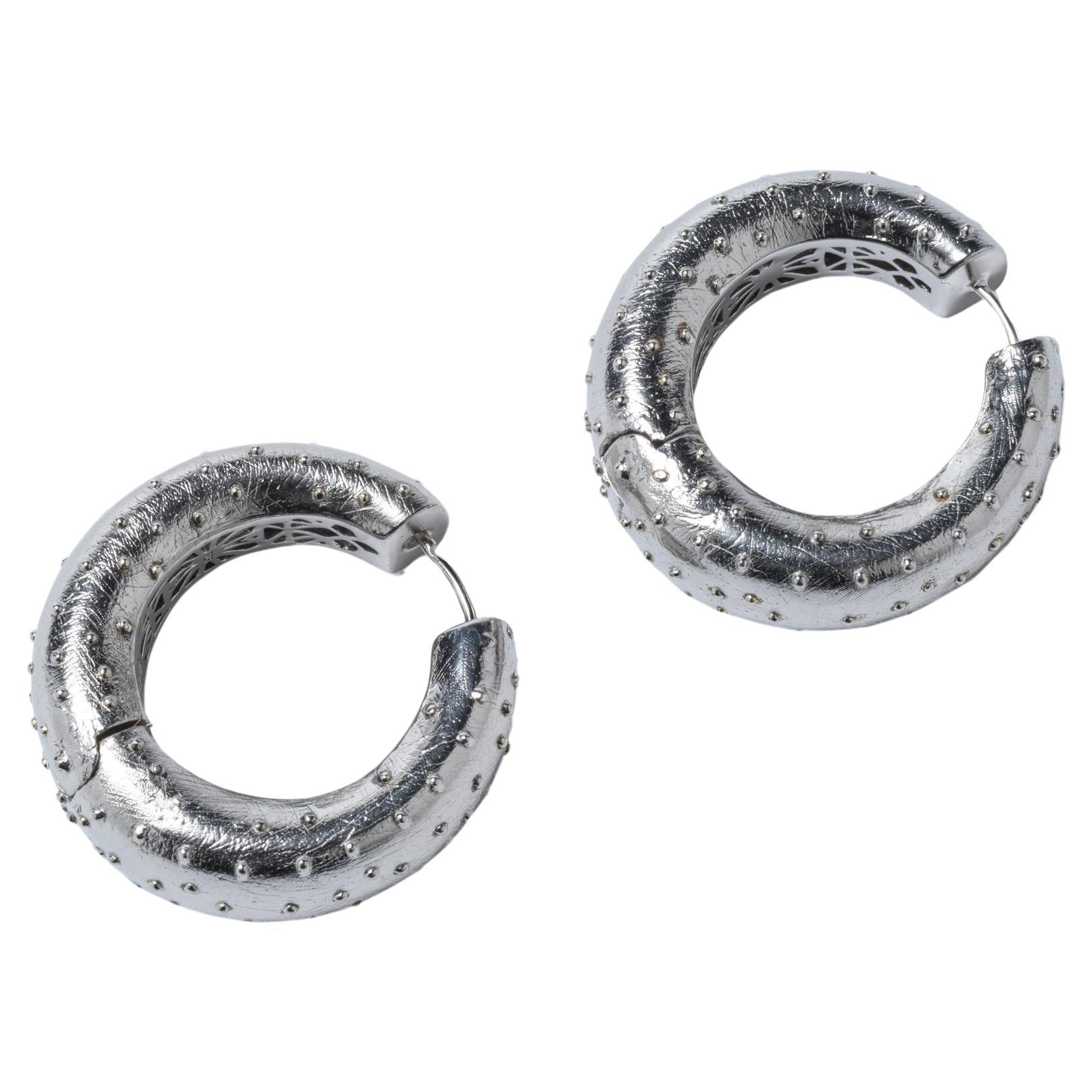 Pair of silver ear rings by Swedish designer Paula Pantolin. For Sale