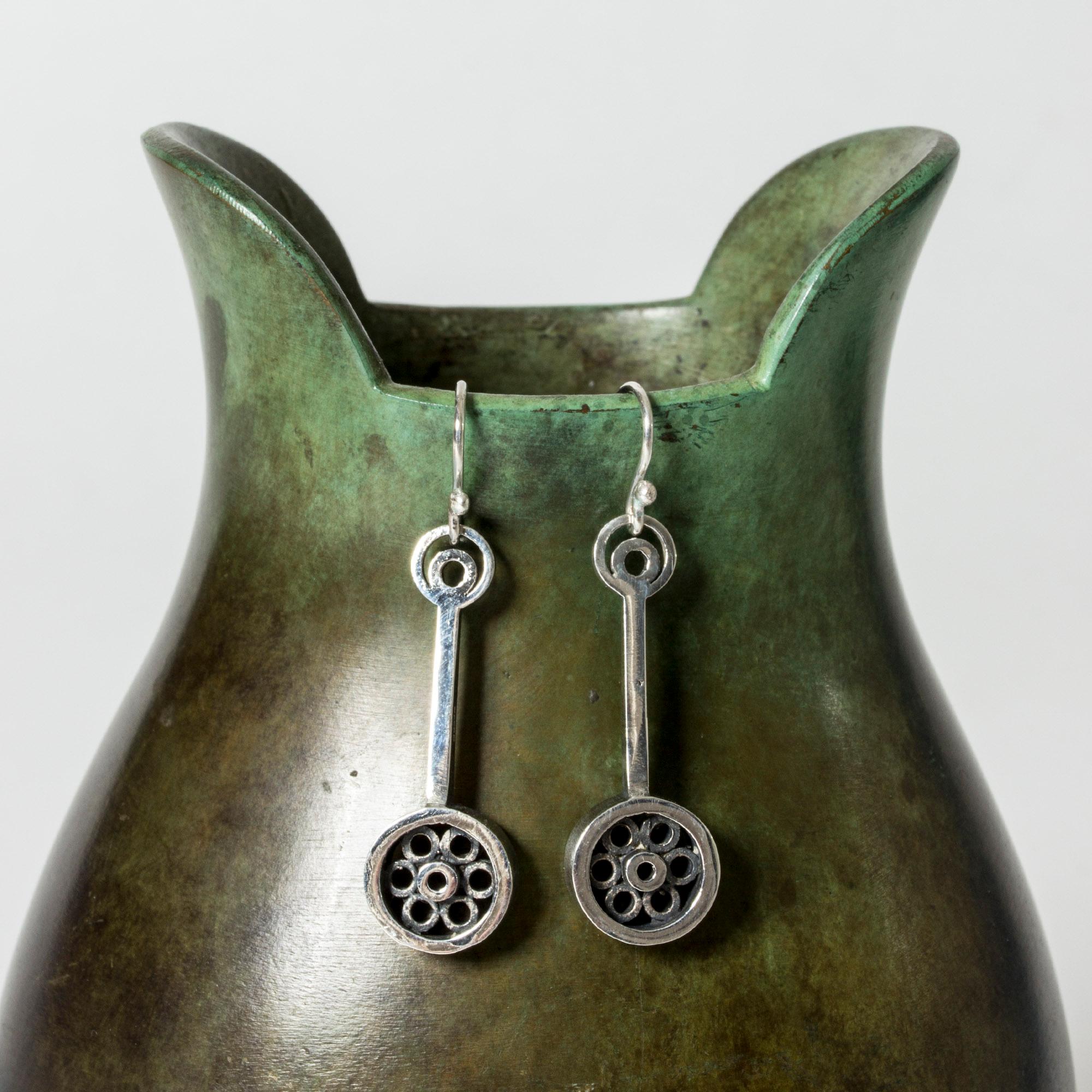 Pair of lovely silver earrings by Gudmund Elvestad, in a cool, graphic design with a pattern of circles.

Original screw mechanism with hallmarks will come with the earrings.