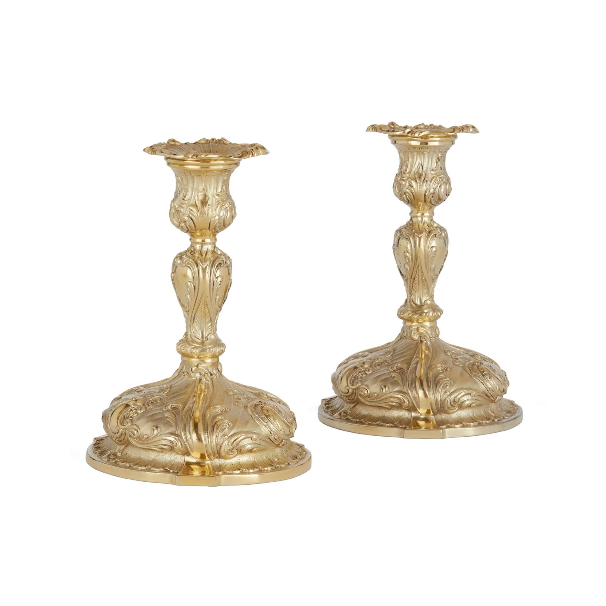 Pair of silver gilt 3-branch candelabra 
Continental, 20th Century 
Height 27cm, width 28cm, depth 12cm

These superb silver gilt candelabra were crafted in the 20th century and their design is inspired by the charming Rococo style. 

The central