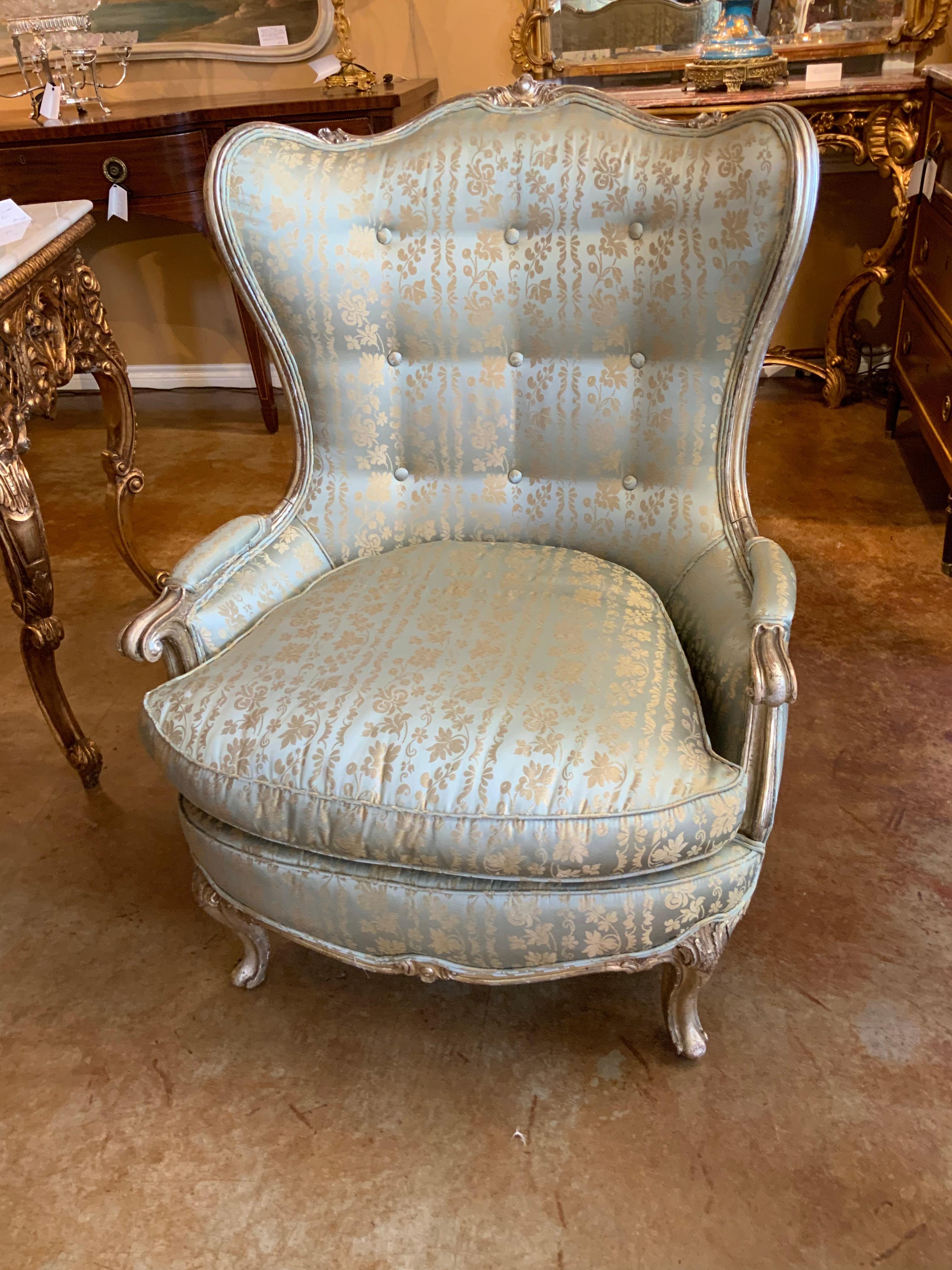 Large silver gilt bergere chair frames in Louis XV- style with cabriole legs
Center cartouche at the crest. Upholstered in a lovely aqua and cream print silk
Fabric without spots or stains.