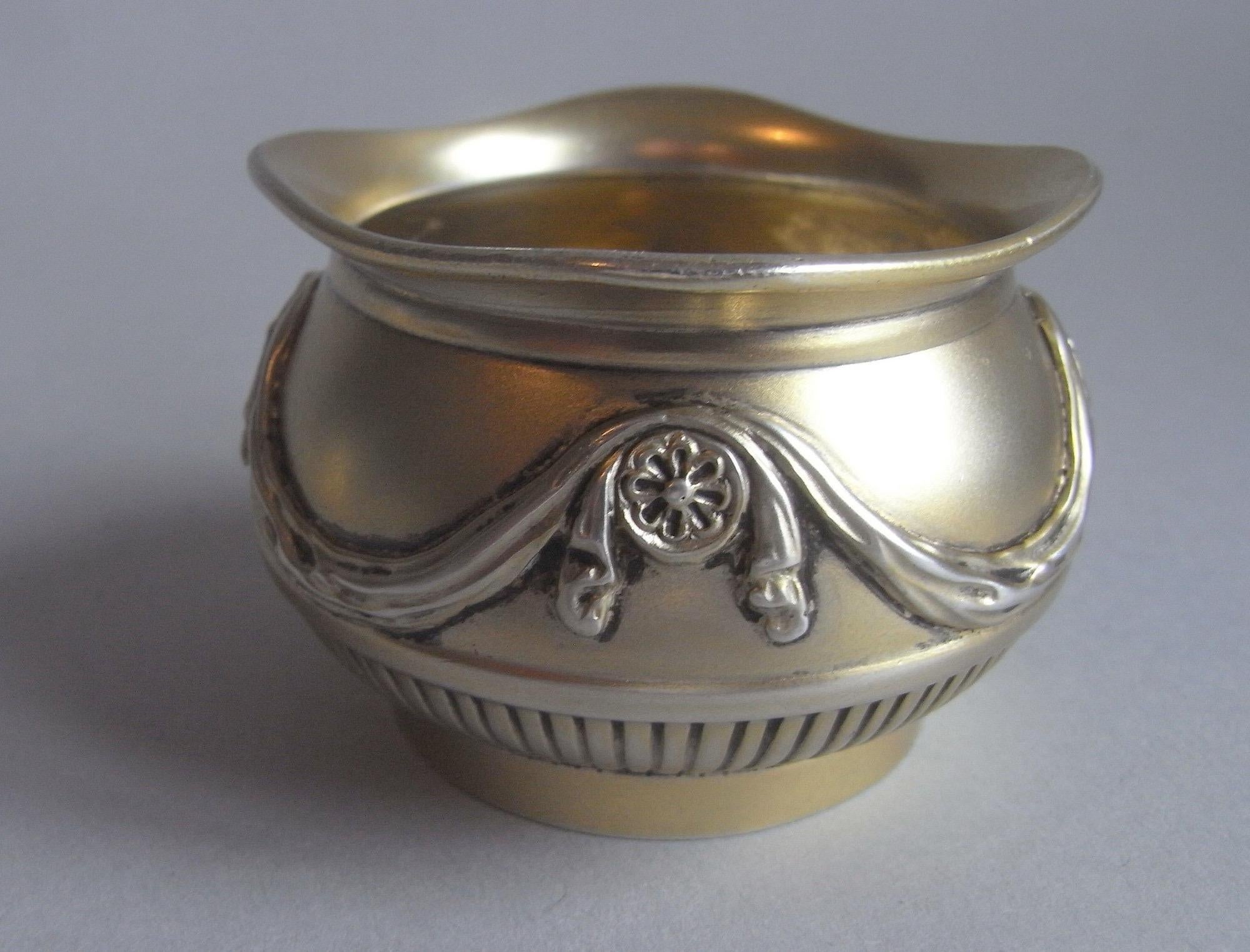 A Very Fine Pair of Silver Gilt Neo-classical Revival Salt Cellars Made in Birmingham by the Famous Firm of Freerick Elkington in 1878.

The Salt Cellars are of a most unusual design and have a baluster form with everted dipping rim. The sides are