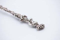 Pair of silver ice-cream spoons with Putti handles and floral shells