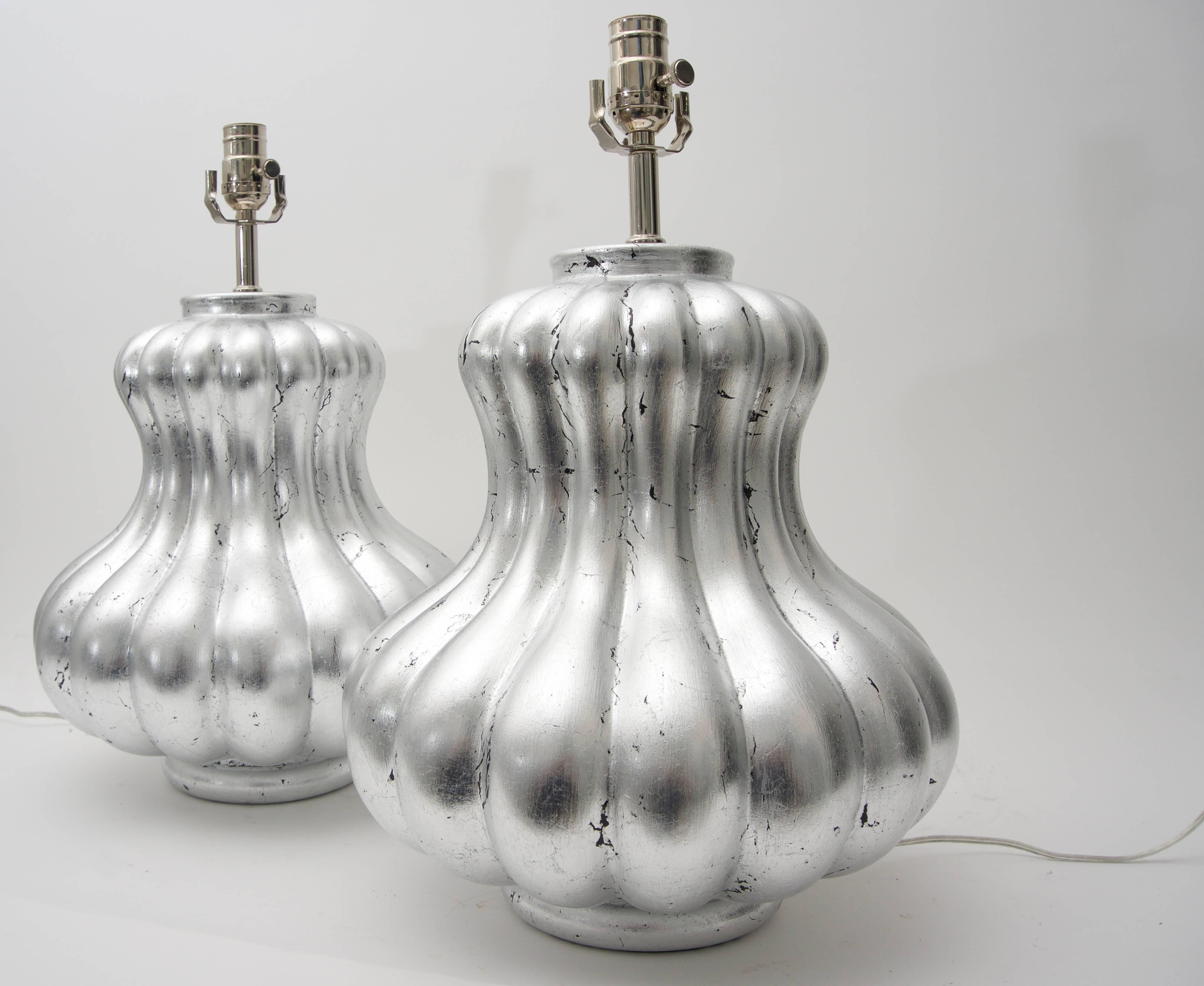 This stylish and chic pair of silver leafed melon-form table lamps were created by Angel and Zevallos of Palm Beach and are one-of-a-kind pieces.

Note: The base is a red bole with hand applied silver leaf.

Note: The lamps have dimmer switches.

 