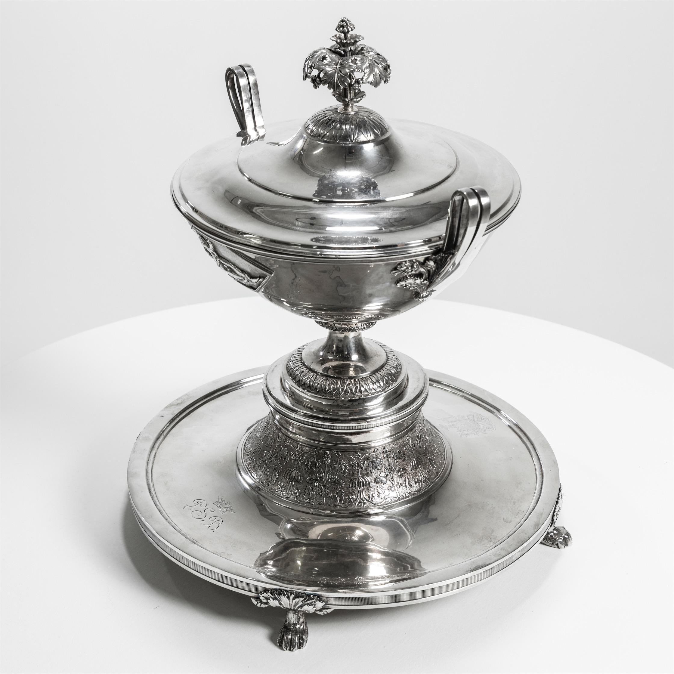 Pair of silver lidded tureens with reclining female figures on the walls and the herb 
