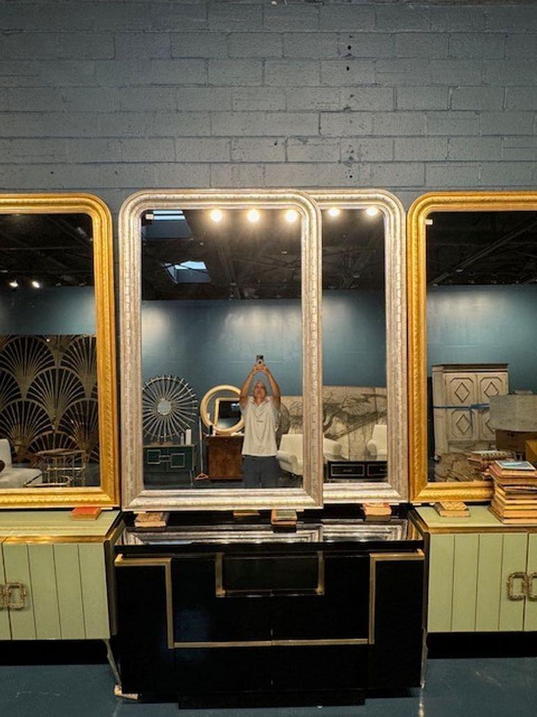 Adorn your space with a touch of classic elegance with this pair of Louis Philippe mirrors. Featuring a sophisticated geometric pattern, these mirrors bring a timeless aesthetic to any room. The subtle silver finish adds a soft sheen, enhancing the