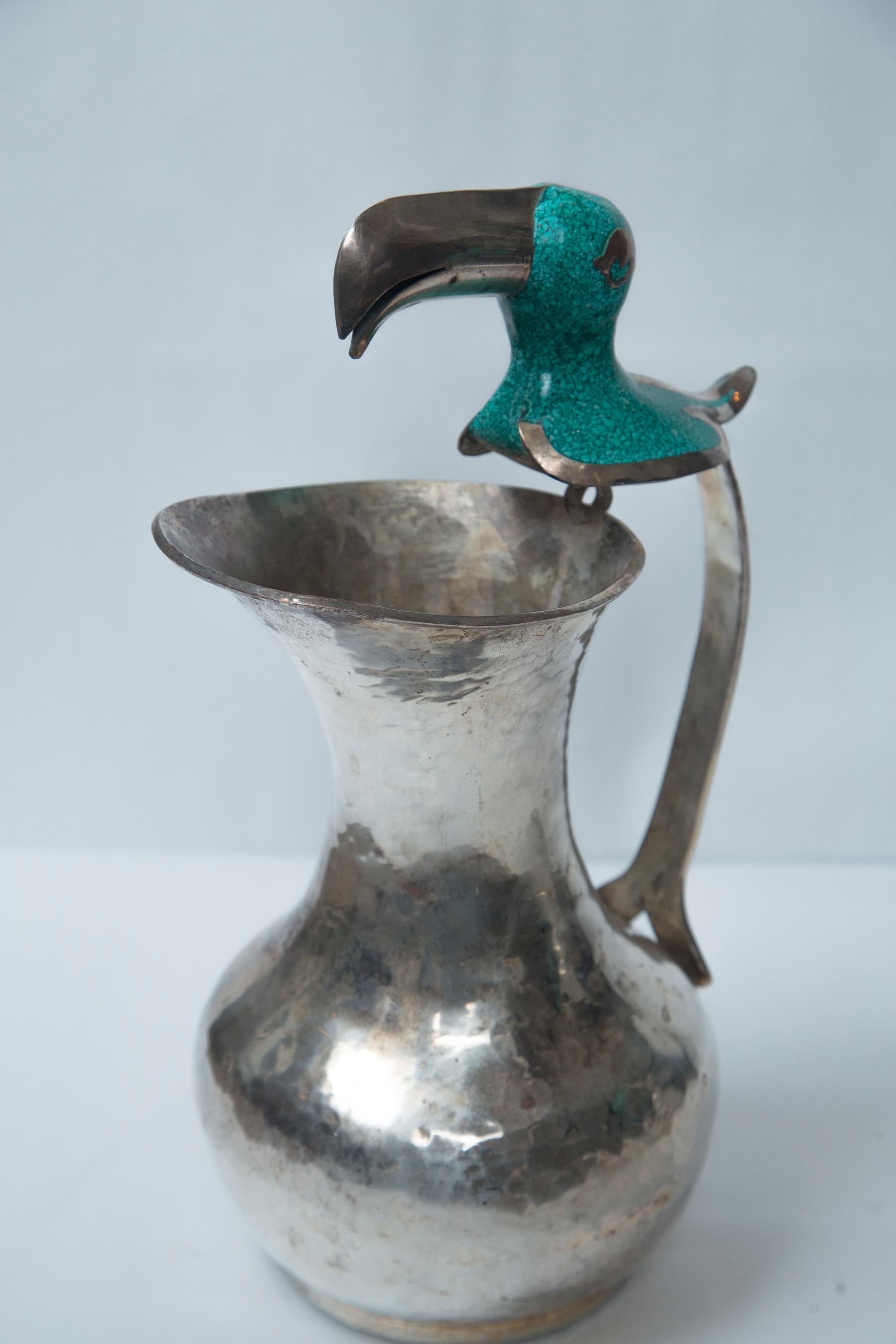 Hammered Pair of Silver on Copper Bird Handled Pitchers For Sale