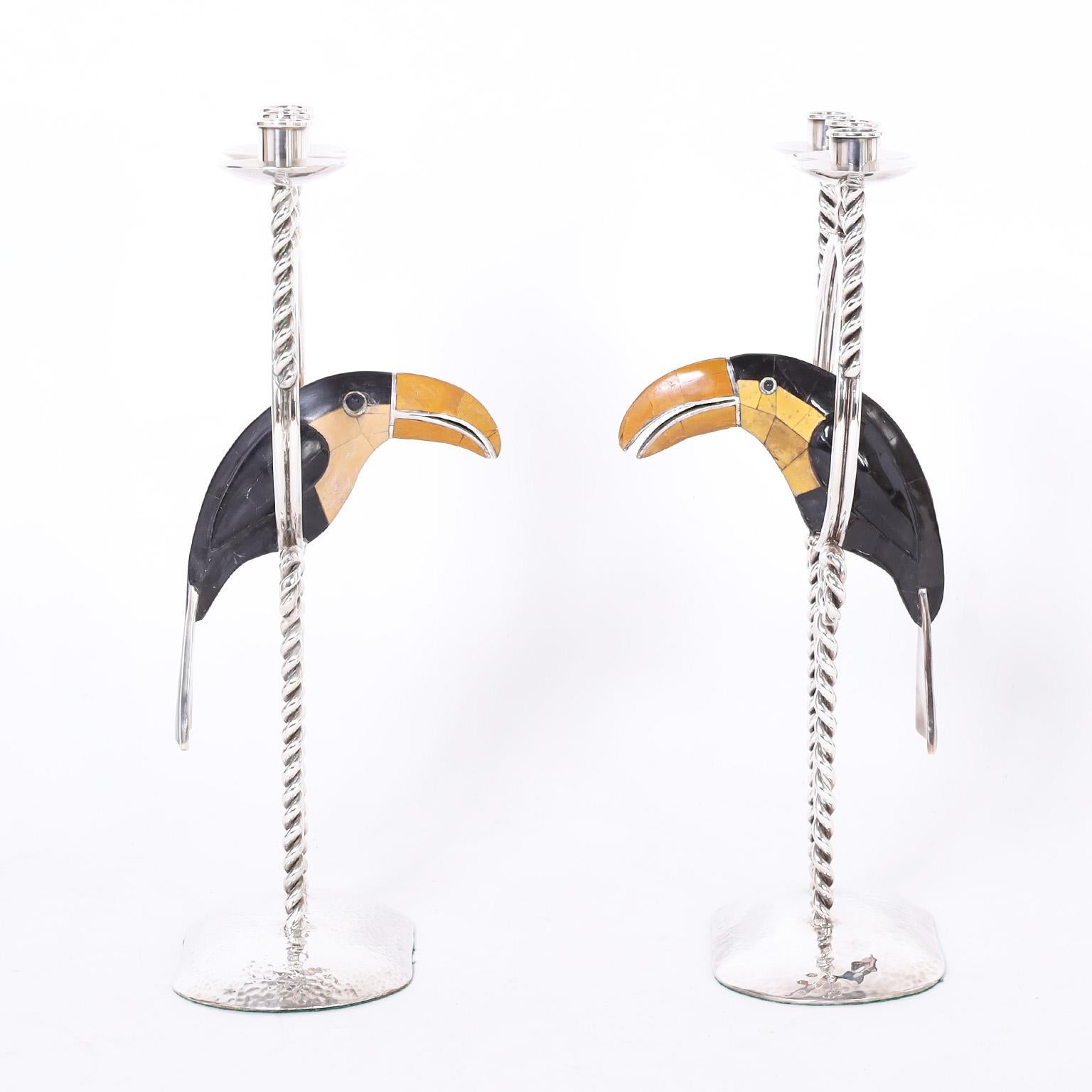 Standout pair of candelabras expertly handcrafted with silver plate on copper in an alluring modern design featuring stone clad toucans perched in the centers. Signed Emilia Castillo Mexico on the bottoms.