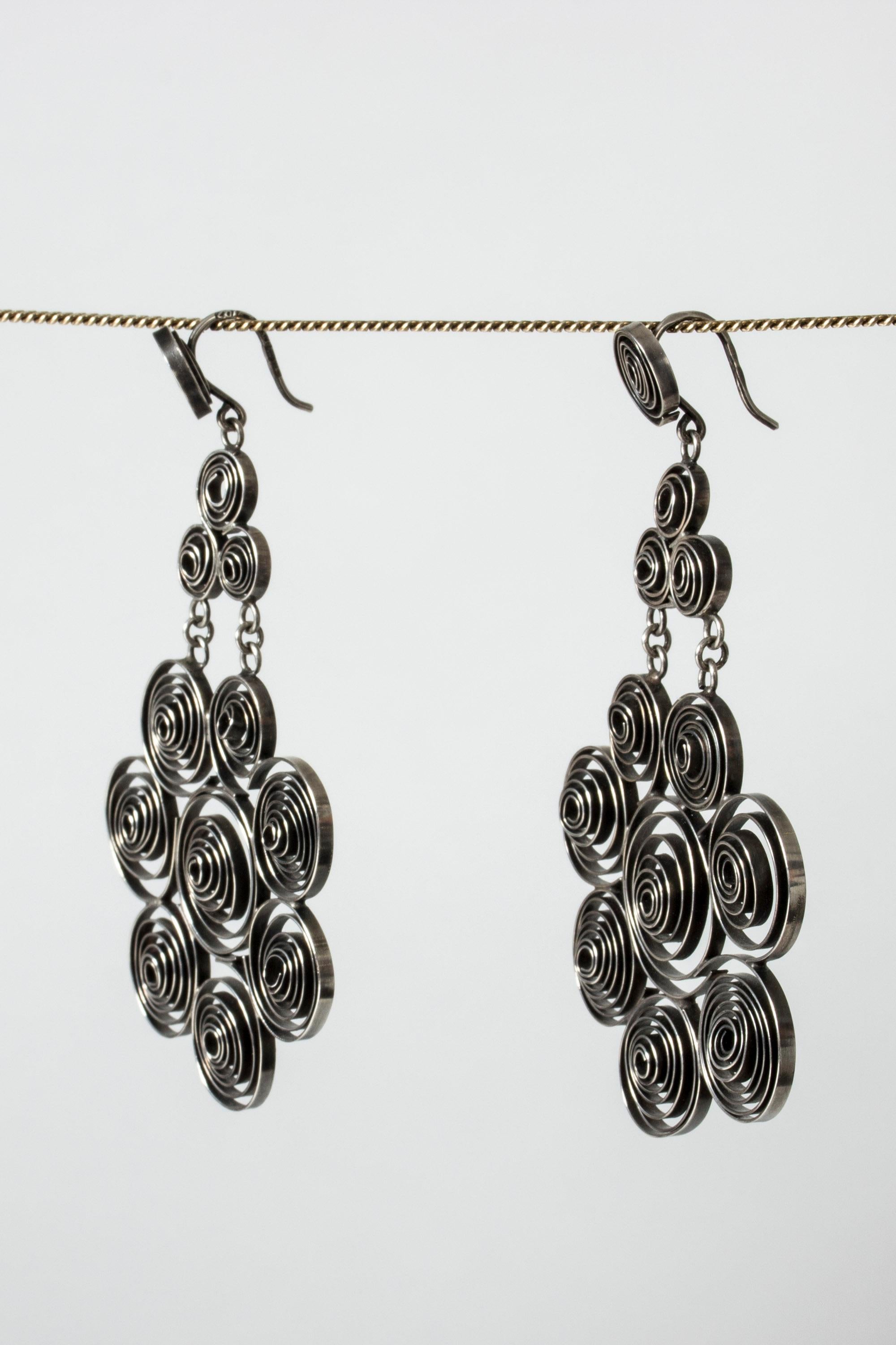 Pair of silver earrings by Liisa Vitali, in an early version of the “Kissantassu” (“Cat paw”) series which was taken into serial production by the firm Nils Westerback in the 1970s. Created from silver ribbons twisted into spheres. Heavy quality.