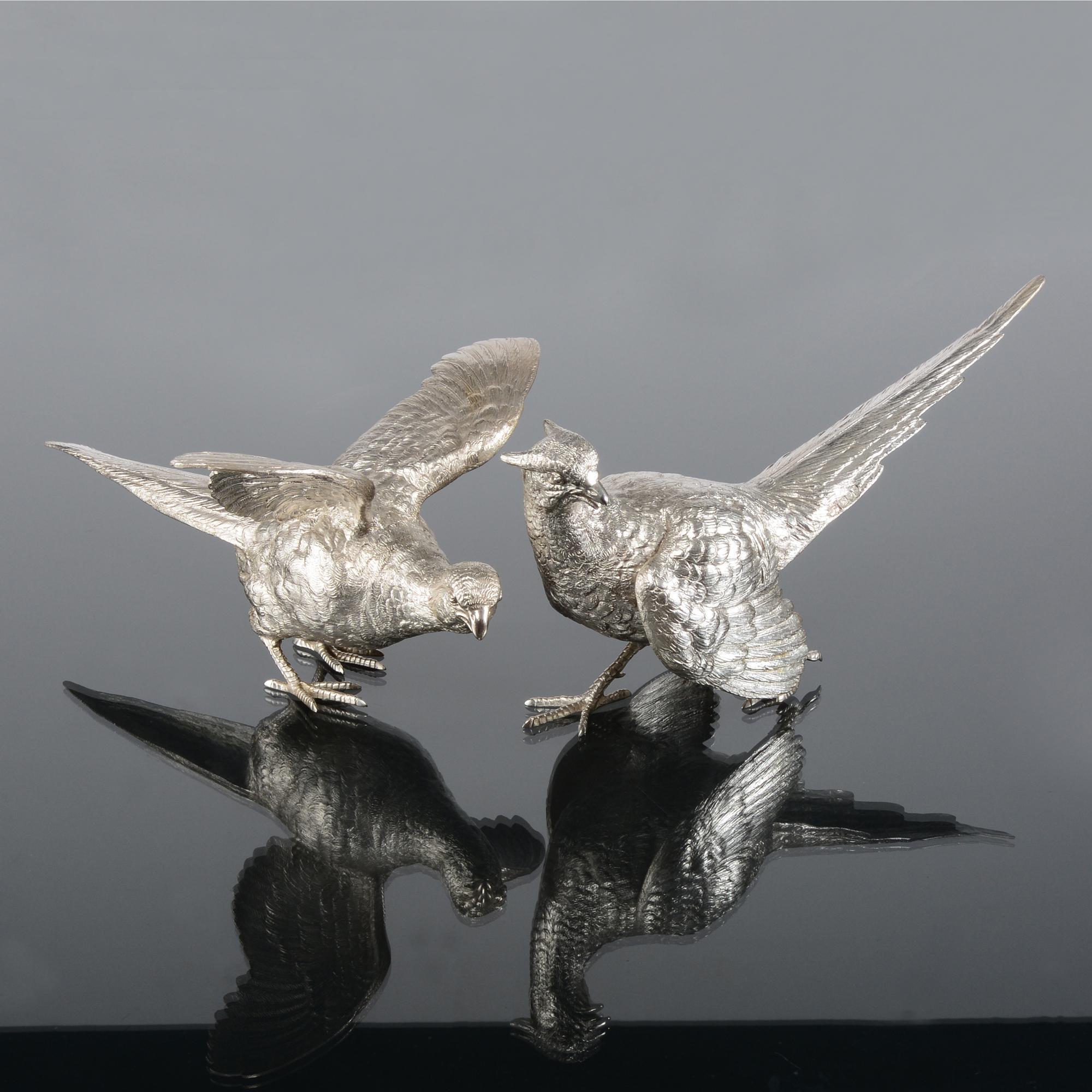 Made by Barnard Brothers for Mappin & Webb, this fine pair of silver pheasants are depicted in a classic pose. This silver cock and hen pheasant couple are particularly fine examples of silver game bird modelling, showing fine quality hand chasing